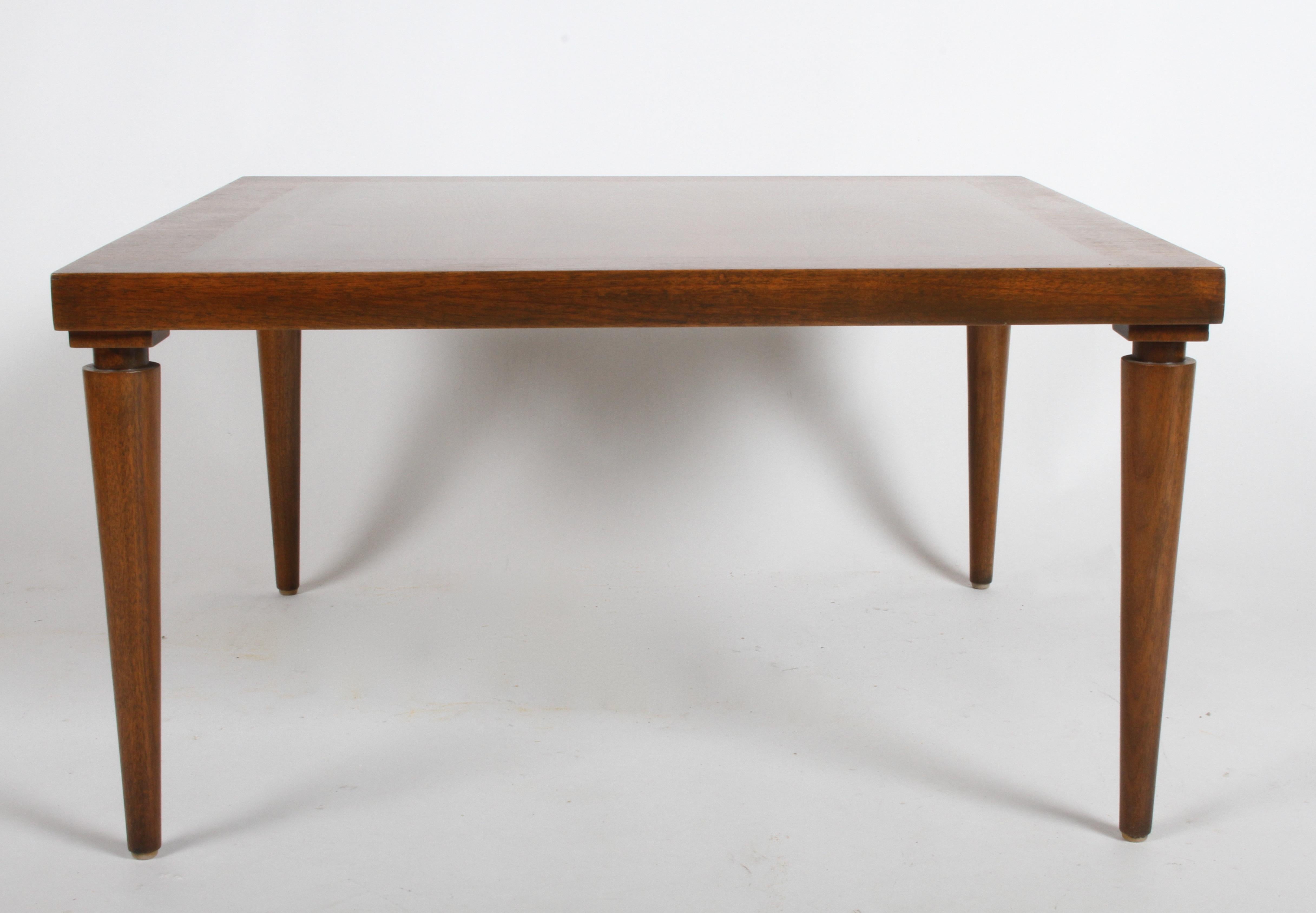 Elegant and not very common walnut table designed by T. H. Robsjohn-Gibbings for Widdicomb, rectangular table with tapered legs with notch in at top. Model 3348, label. Similar to his designs for Saridis. Refinished.