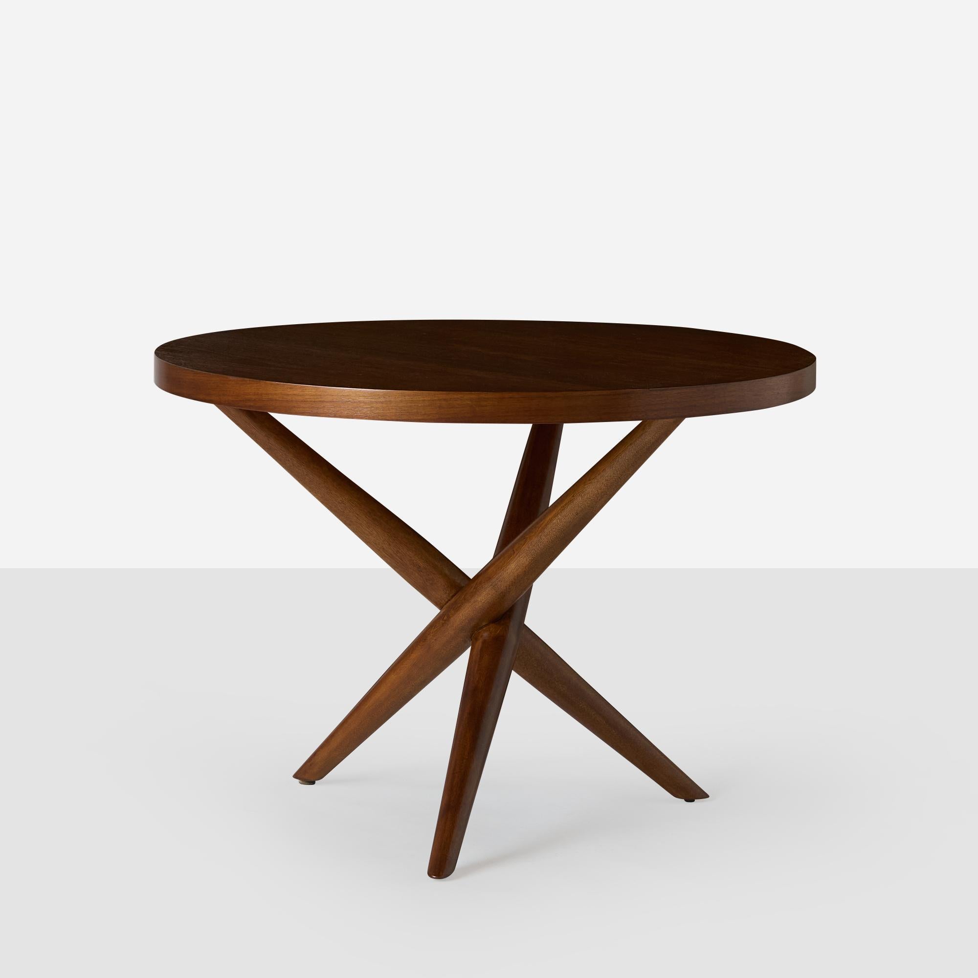 A walnut tripod occasional table by T.H. Robsjohn-Gibbings for Widdicomb Furniture, Model #1641. Marked accordingly.