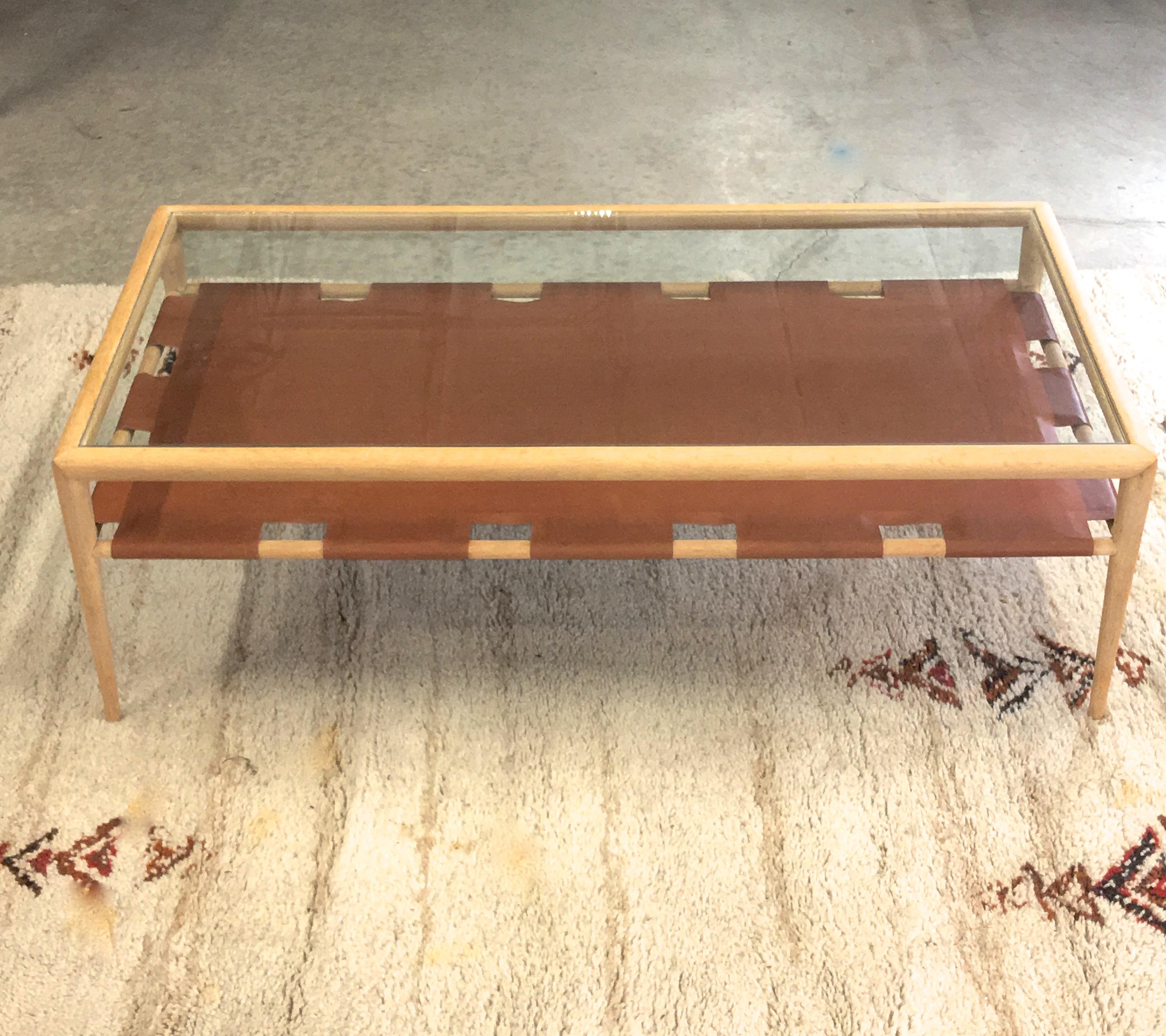 Robsjohn-Gibbings for Widdicomb two tier rectangular coffee table, light birchwood frame with tapered legs, single hide French calfskin cognac leather on board with crenelated tabs wrapped around stretchers, and new tempered glass top. Partial label