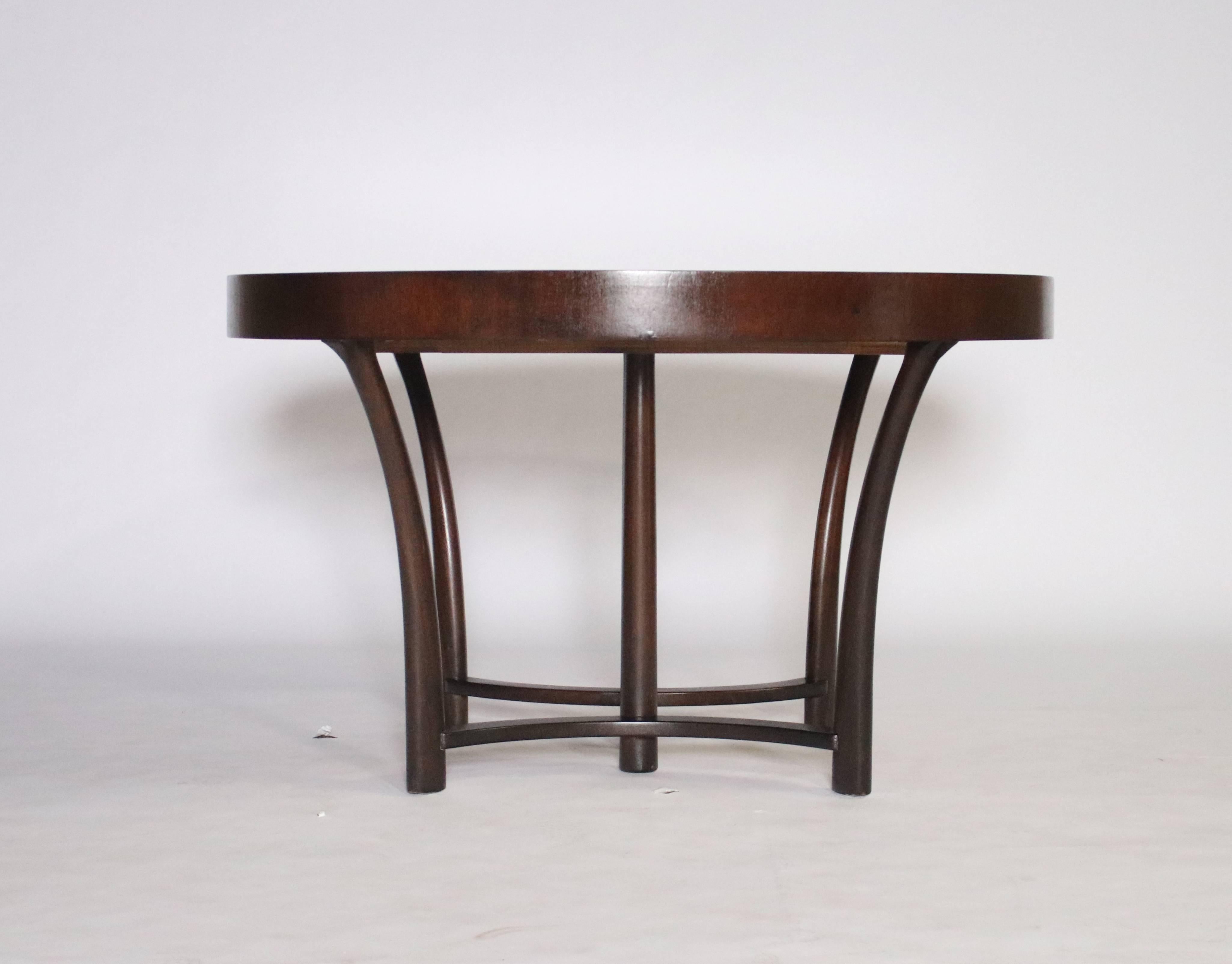 T.H. Robsjohn-Gibbings style extension dining table by Widdicomb, circa 1938 in mahogany with sunburst parquetry top. Extendable table includes 3 leaves all consistent with the color of the table totaling 84