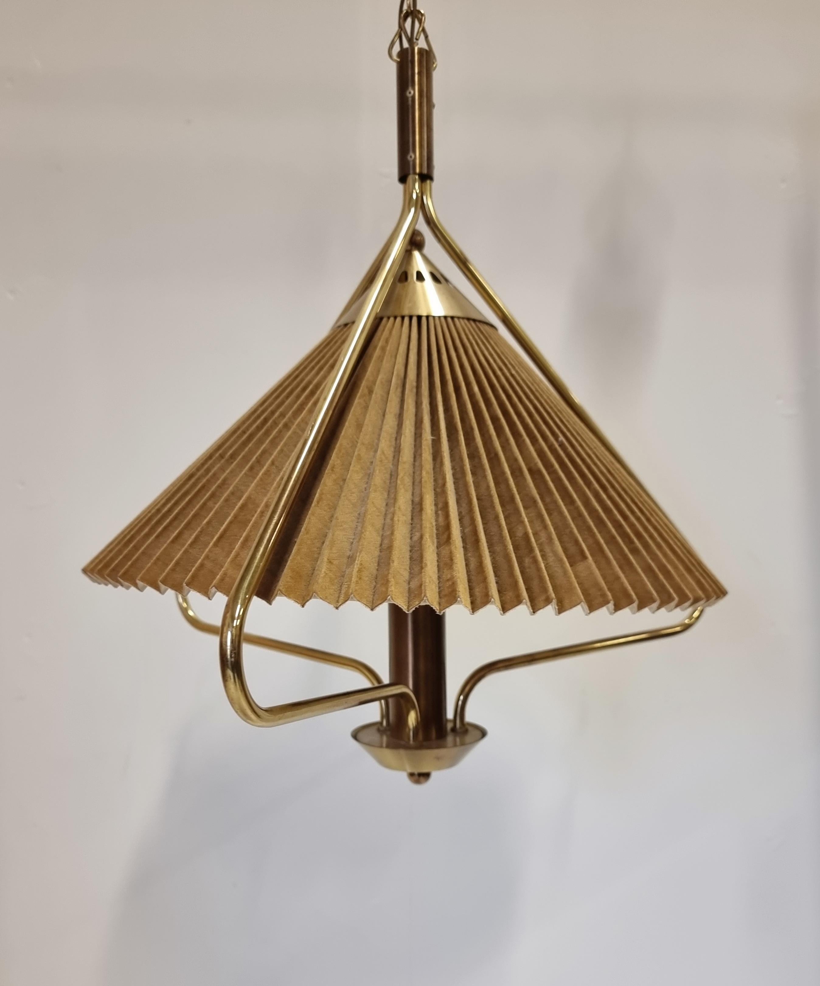 Pendant in brass and pleated lampshade with suede-like fabric in dark golden-brown. Made by T. RØSTE & CO, marked: TR & CO 449. This is a rare model made in Norway, midcentury / Scandinavian Modern. 

Total height with original chain 142 cm. In good