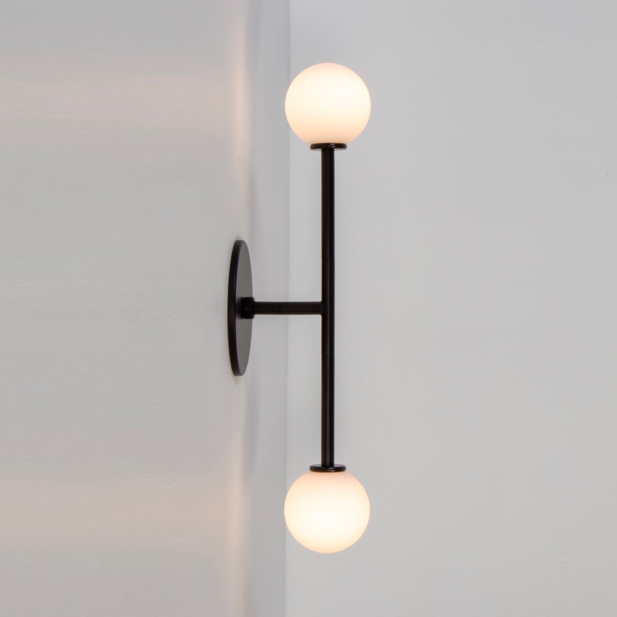 This listing is for 1x T Sconce designed and manufactured by Research.Lighting. 

Materials: Steel, Glass
Finish: Powder Coated Steel in black
Electronics: 2x G9 Sockets, 2x 4.5 Watt LED Bulbs (included), 900 Lumens total
UL Listed. Made in the USA
