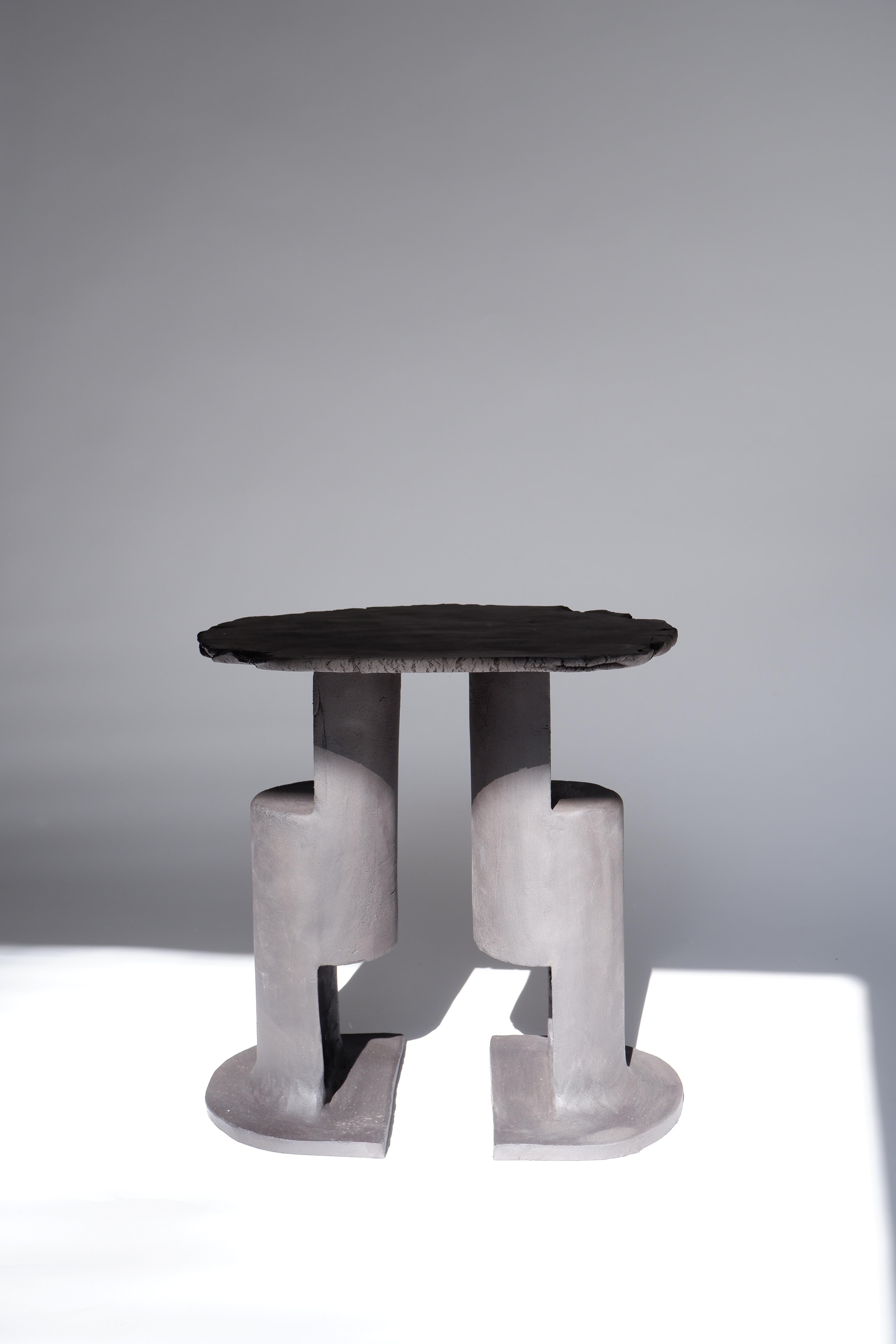 T01 Coffee Table by Ia Kutateladze
One Of  A Kind.
Dimensions: D 38 x H 37 cm.
Materials: Black clay.

Each piece is one of a kind, due to its free hand-building process. The top is always irregular and one of a kind. Possible material variations: