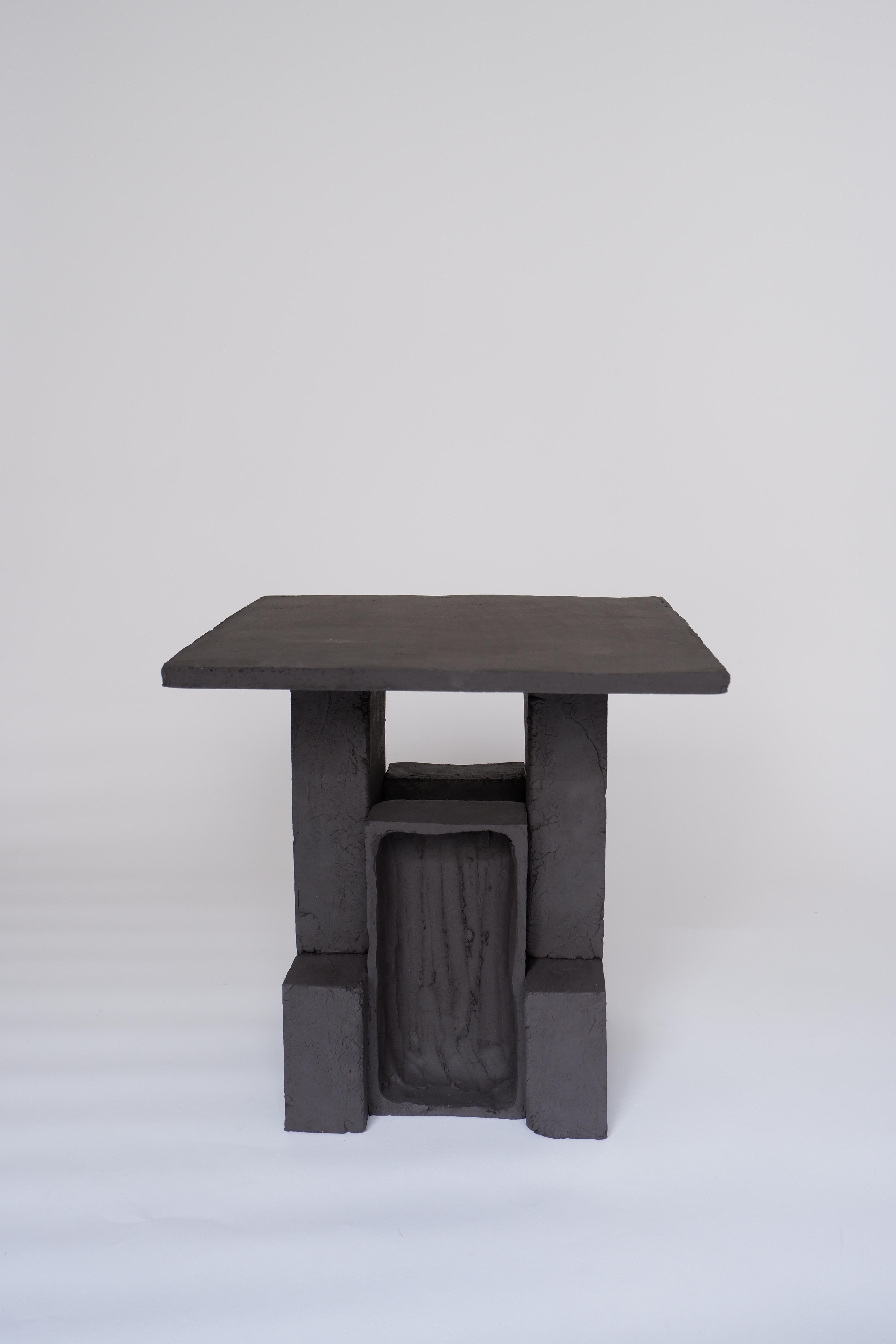 T03 Coffee Table by Ia Kutateladze
One Of  A Kind.
Dimensions: D 35 x H 37 cm.
Materials: Black clay.

Each piece is one of a kind, due to its free hand-building process. The top is always irregular and one of a kind. Possible material variations: