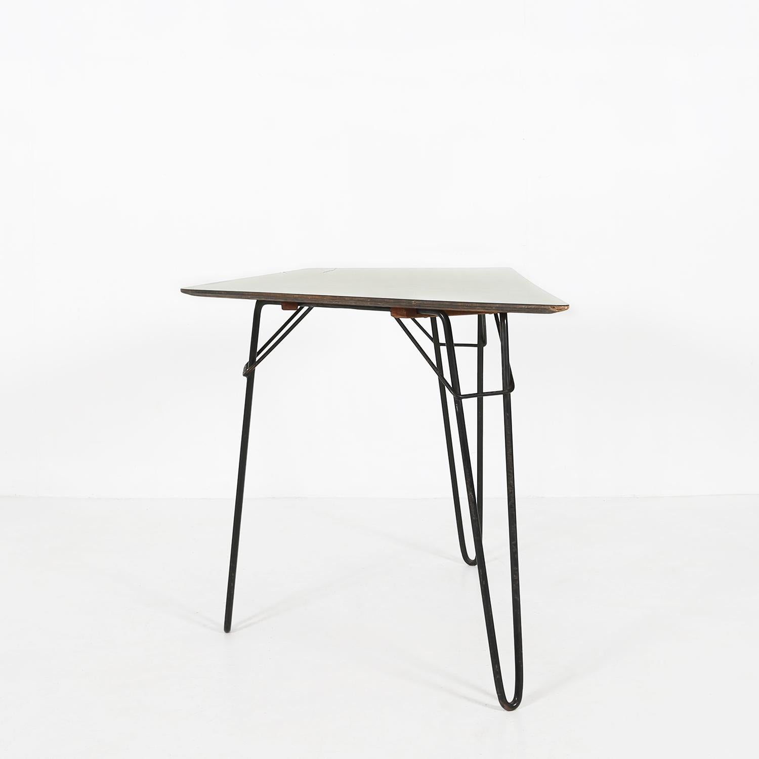 T1 dining table designed by Willy Van Der Meeren for Tubax in 1954.
Made of a black painted metal base and a wooden top with light yellow formica top.

There has been some small restorations don on the table top.
The tables are in a good vintage