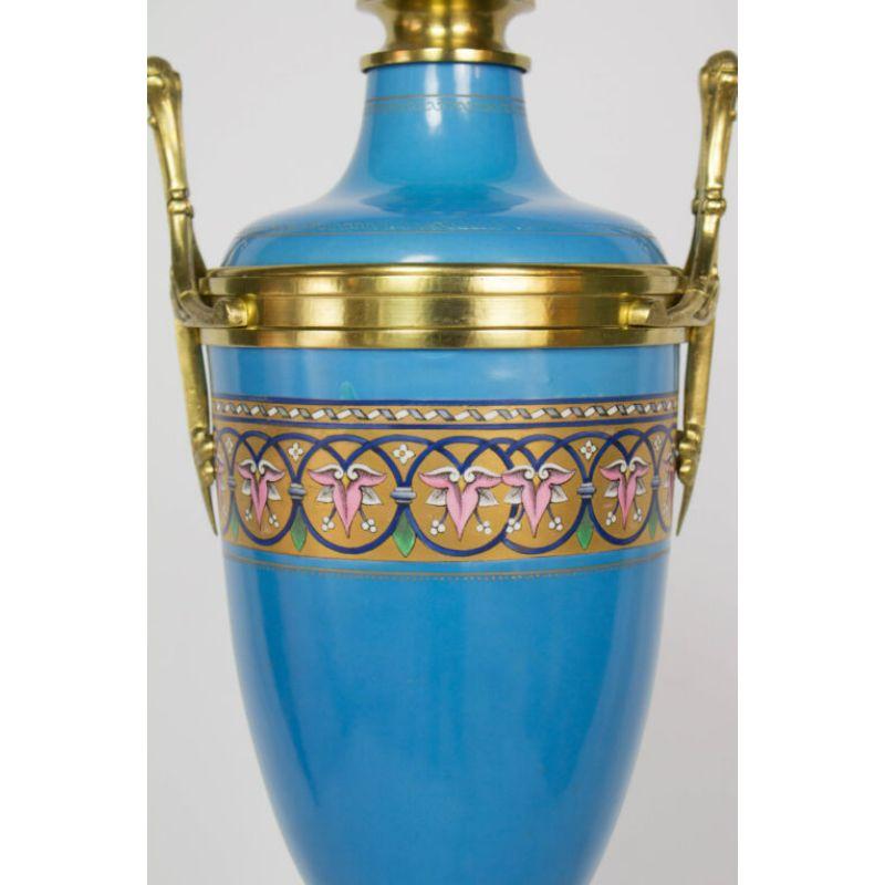 Blue sevres style porcelain lamp with a wooden base. Gilt bronze fittings, porcelain. Pink orchids painted in bands around the middle. Blue painted wooden base. An exceptional 19th century piece

Material: porcelain, bronze
Style: