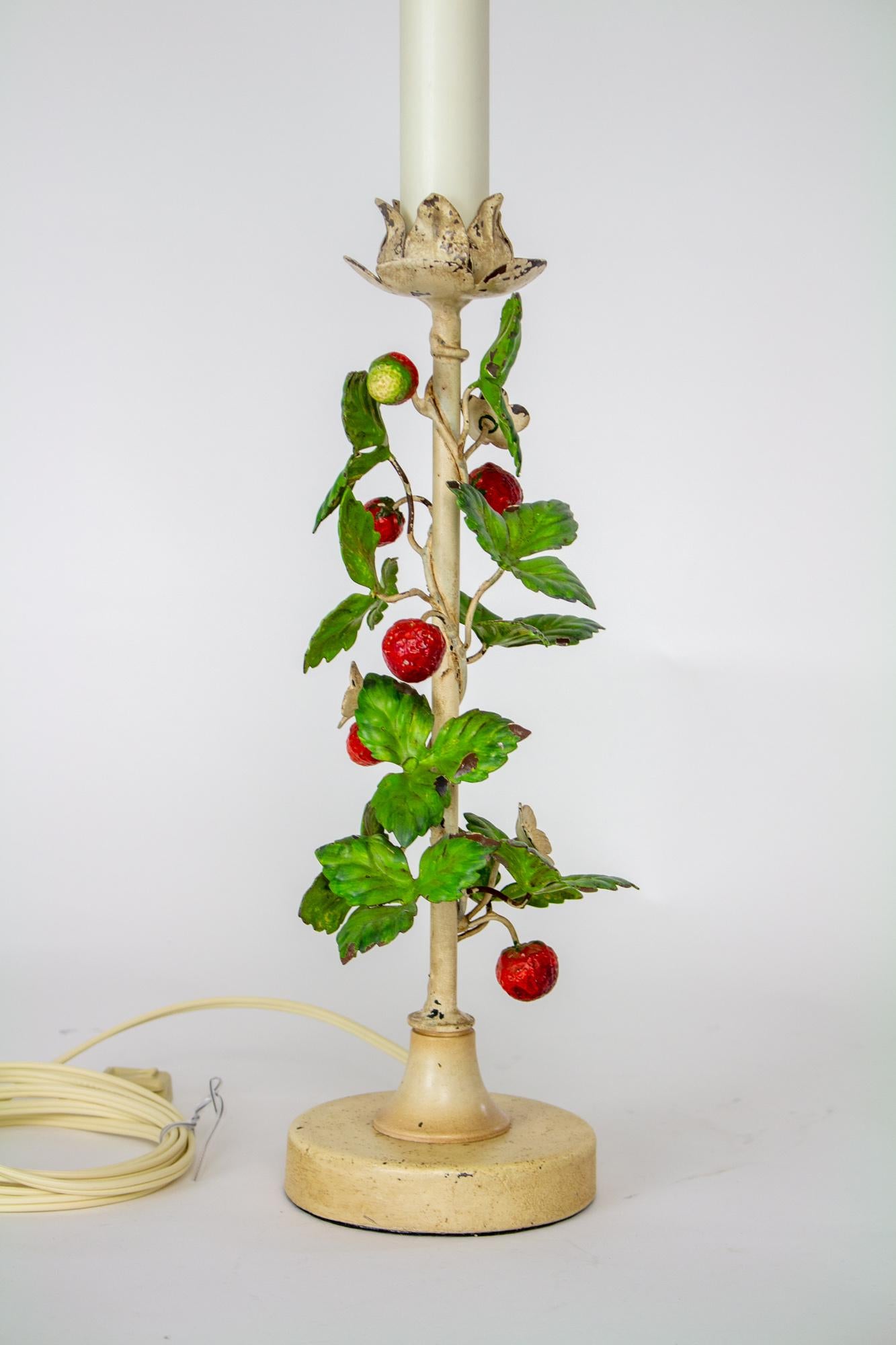 Vintage tole strawberry lamp. Original antique white painted finish with curved branches of strawberry leaves and fruit winding around the stem. Original painted finish in aged condition. Clean, but with some chips as shown in photos. Rewired with