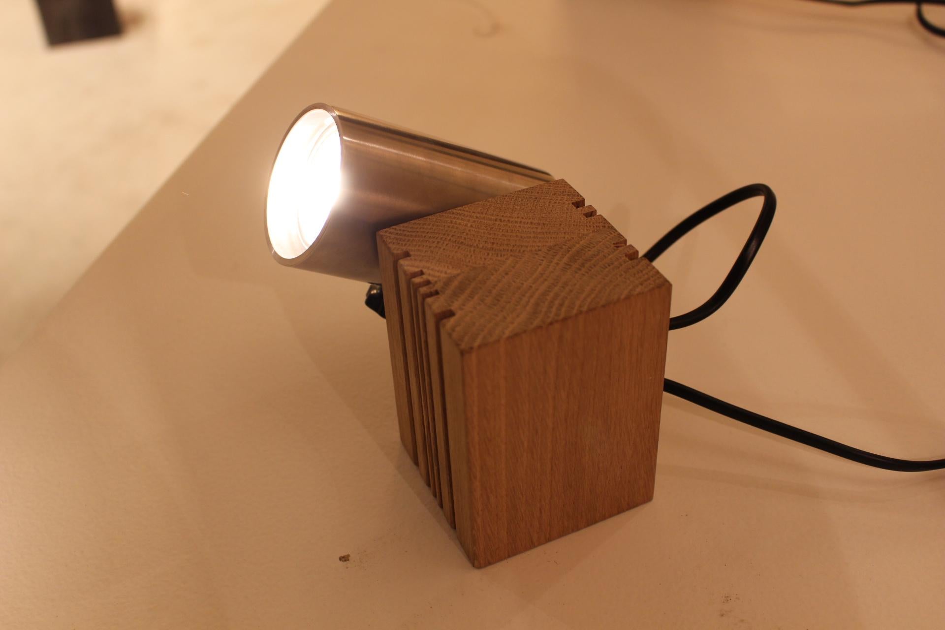 The Wooden Lamp, designed by Belgian interior architect and designer Christophe Gevers, exemplifies his mastery in combining natural materials with minimalist design. This lamp features a sleek wooden structure that highlights the inherent beauty