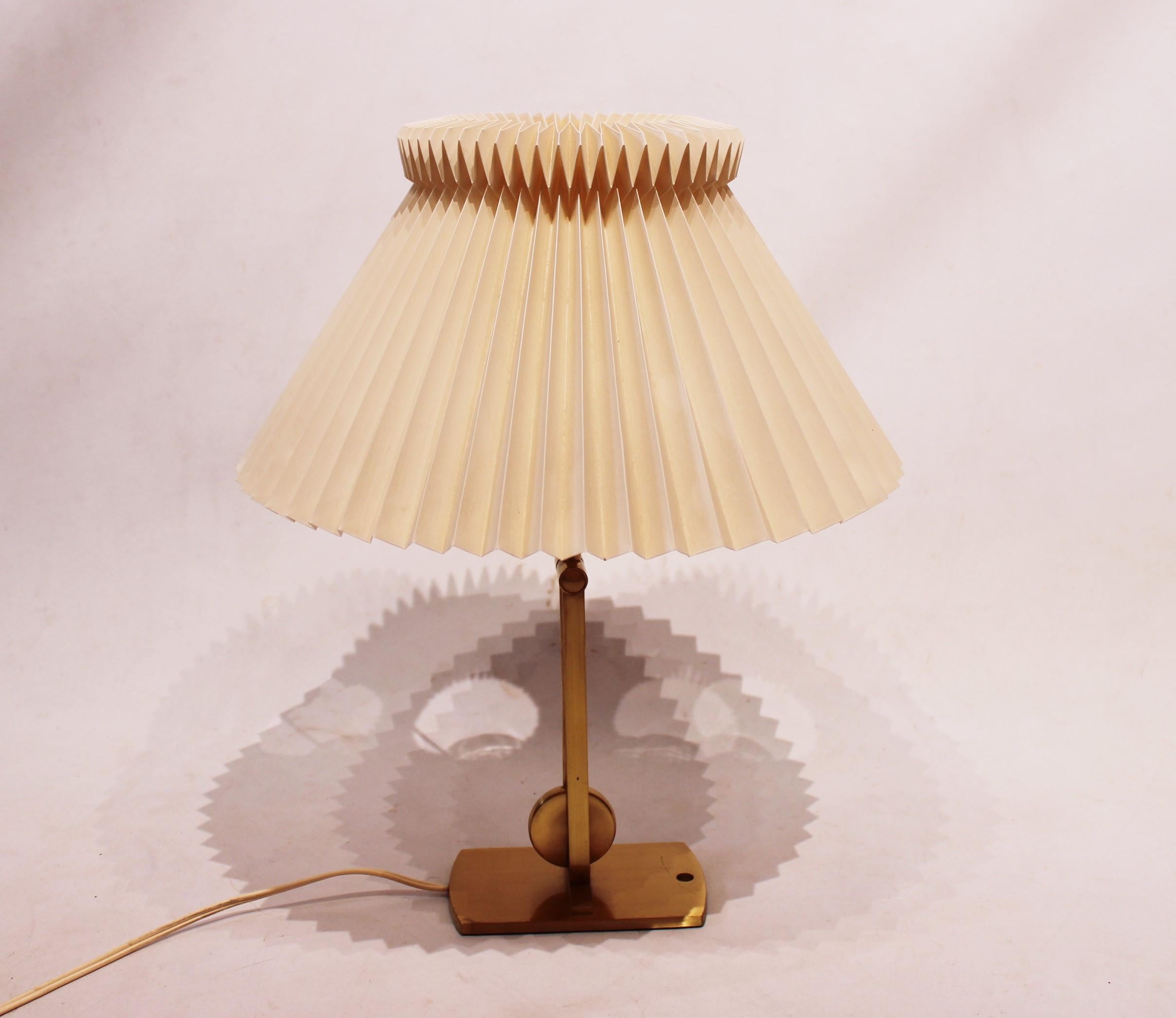 Table- and wall lamp, model 340, manufactured by Le Klint. The lamp is made of brass and can be adjusted. The lamp serves as both table- and wall lamp.
