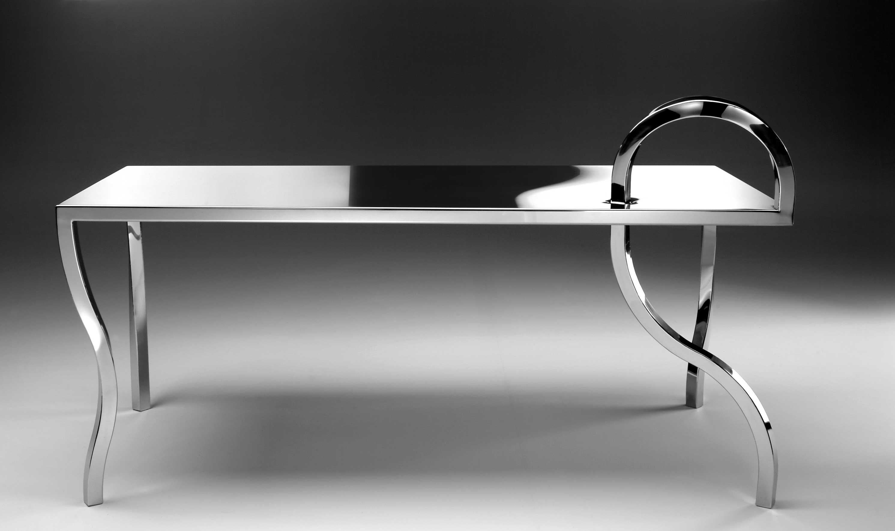 Table - Anomalie Collection designed by Gio Minelli
Materials: Steel
Dimensions: 180 x 80 x h 76 cm

Collection made of polished stainless steel, handmade.
All these pieces have a common character: the curved, twisted legs. An idea of rebellion but
