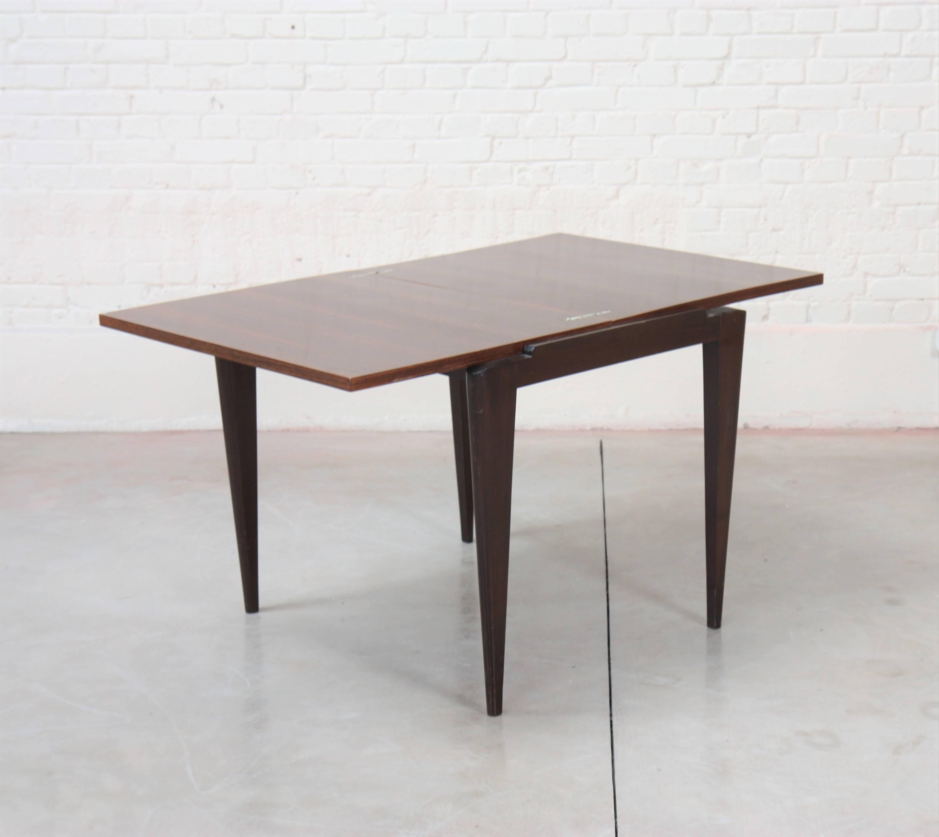 Rectangular table with folding tray in rosewood resting on four tapered legs.

Maurice Jallot (1900-1971) is the son of Léon Jallot. Like his father Léon, Maurice is a wood carver, cabinet maker and decorator. After graduating from the Ecole Boule