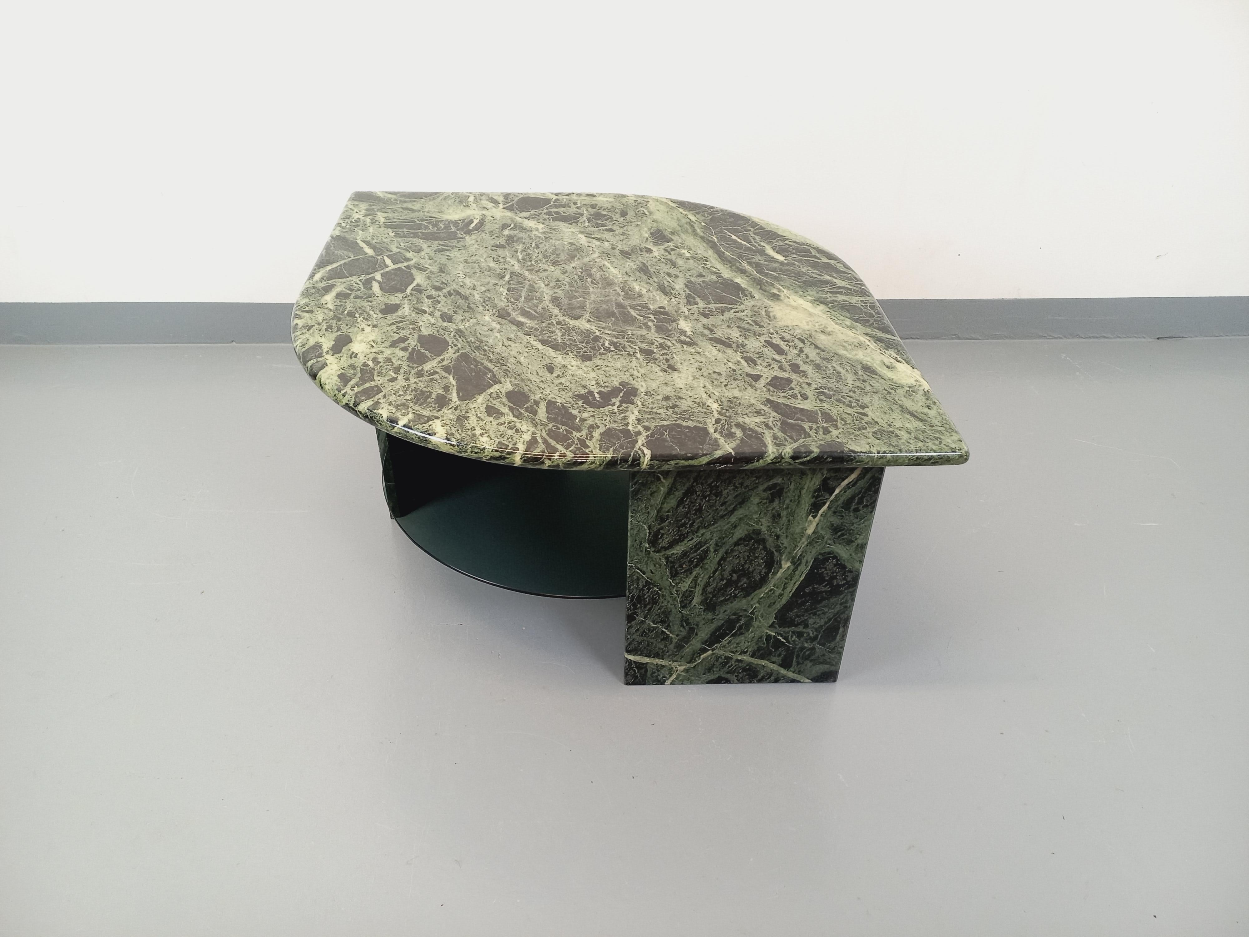Table basse vintage des années 70, magnifique marbre vert avec très beau veinage vert jade, noir et gris foncé, forme carrée arrondie sur deux angles (ou forme d'oeil), deux pieds triangulaires, plateau inférieur rond porte-revue en verre fumé.