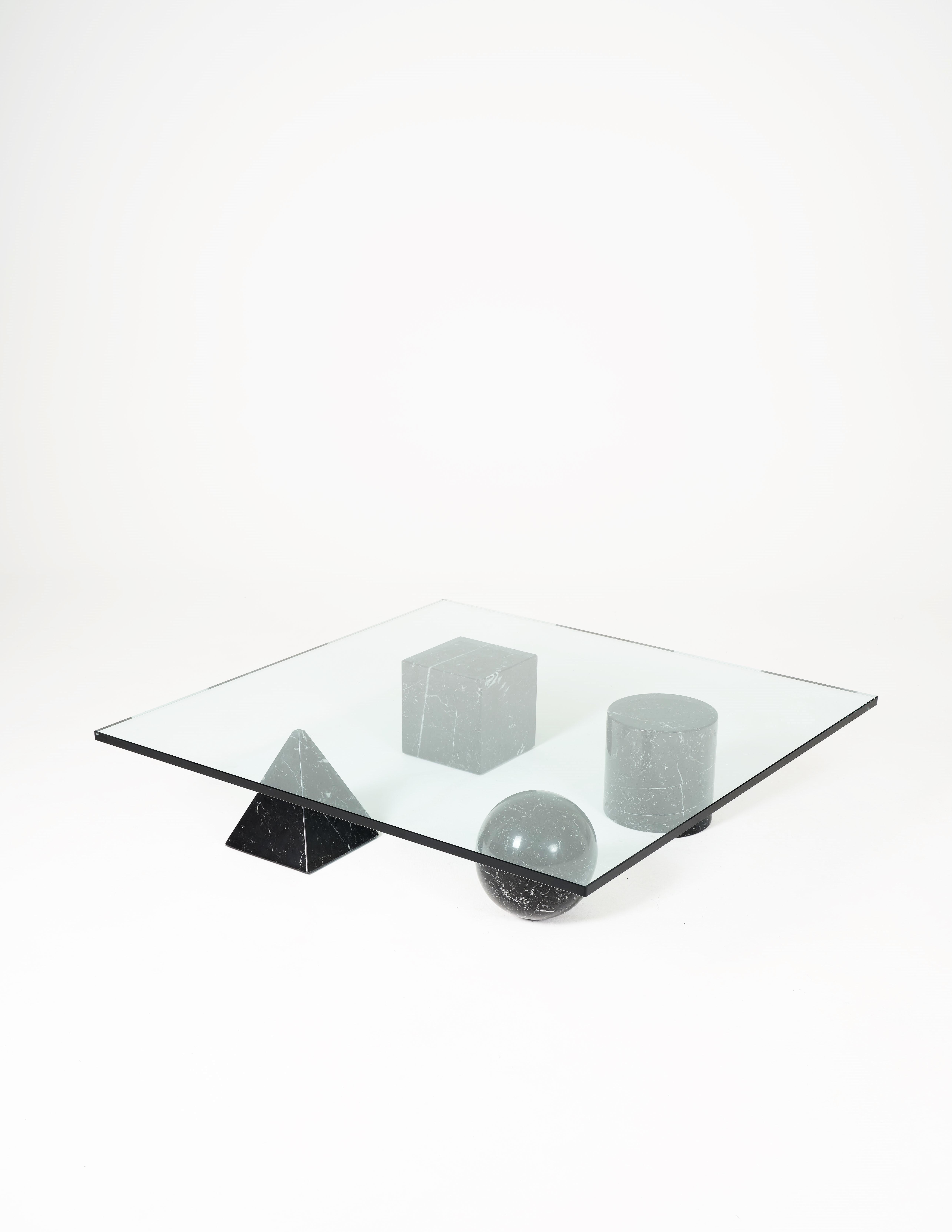 Italian geometric coffee table in travertine, marble and glass by Massimo and Lella Vignelli, 1979. The marble legs can be arranged in any way. 
Dimensions H23 X W120 X D60. Vintage edition.
 