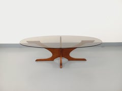 Table basse ovale vintage Hugues Poignant en teck et verre fumé des années 60 70