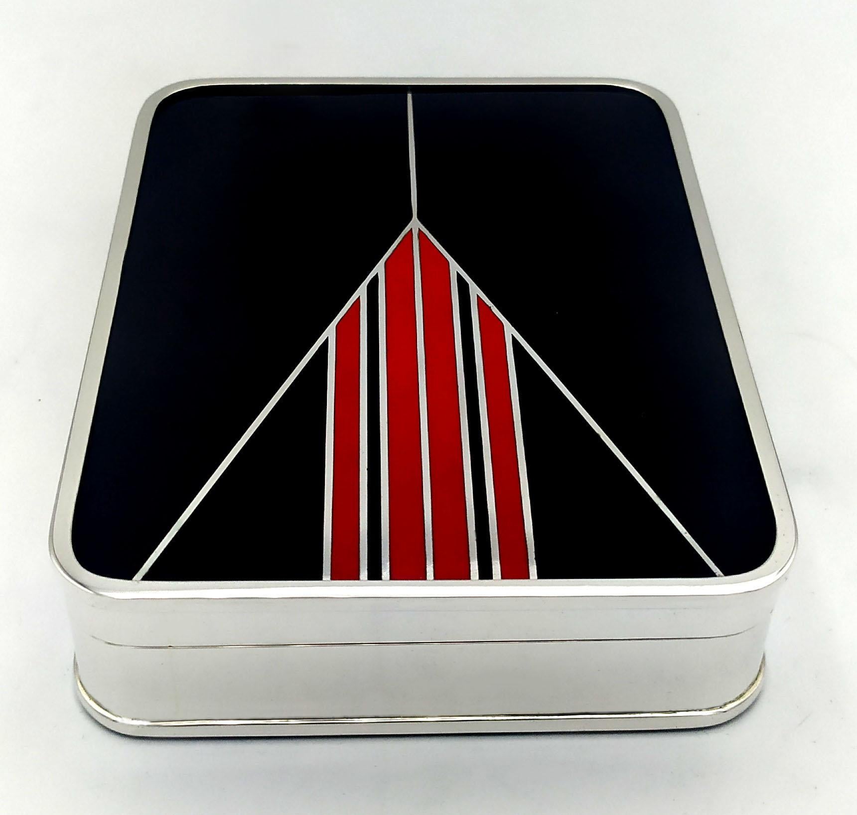 Rectangular table box with rounded corners in 925/1000 sterling silver with fire-enamelled Art Deco design. Dimensions cm. 10.4 x 13.4 x 3.2. Weight gr. 530. Designed by Giorgio Salimbeni in 1976 inspired by objects designed by Louis Cartier around