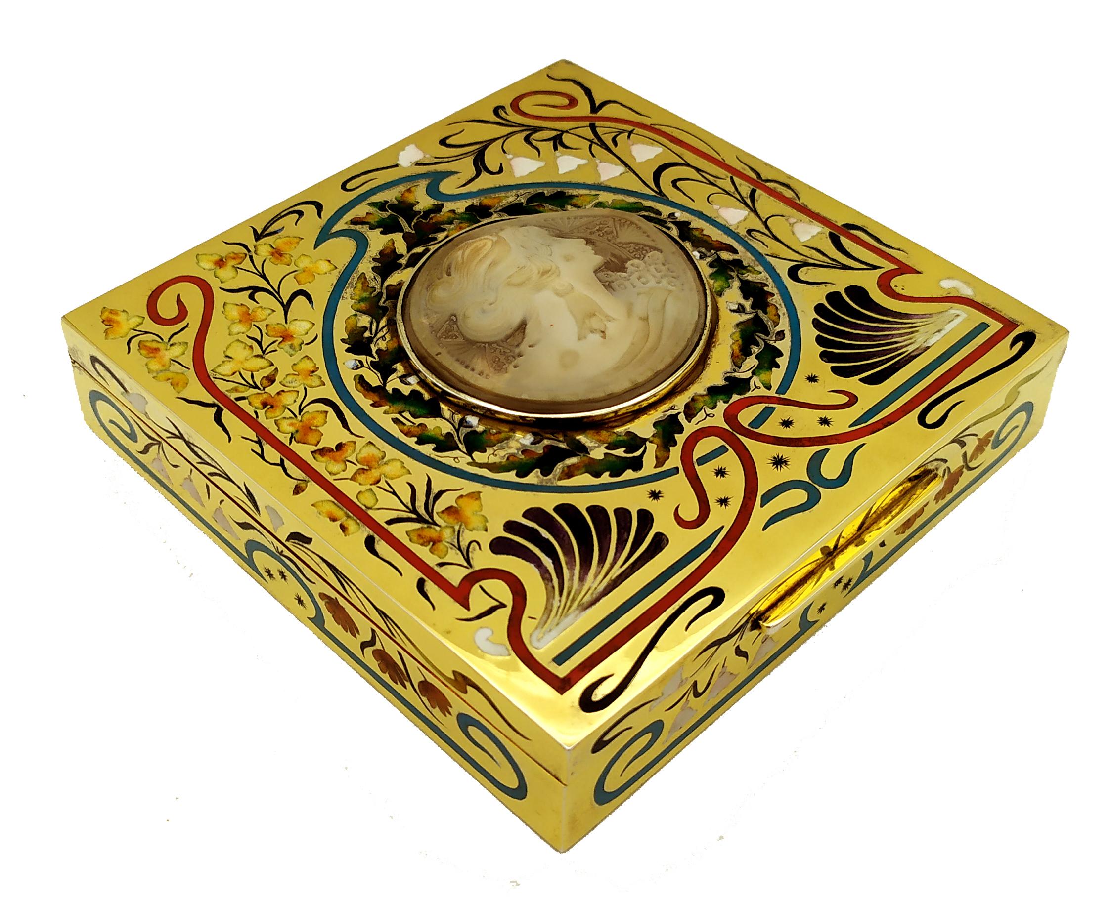 Behold the epitome of elegance and craftsmanship: a square table box, meticulously crafted from gold-plated 925/1000 sterling silver. This masterpiece features exquisite engravings and vibrant polychrome fired enamels in the timeless Art Nouveau