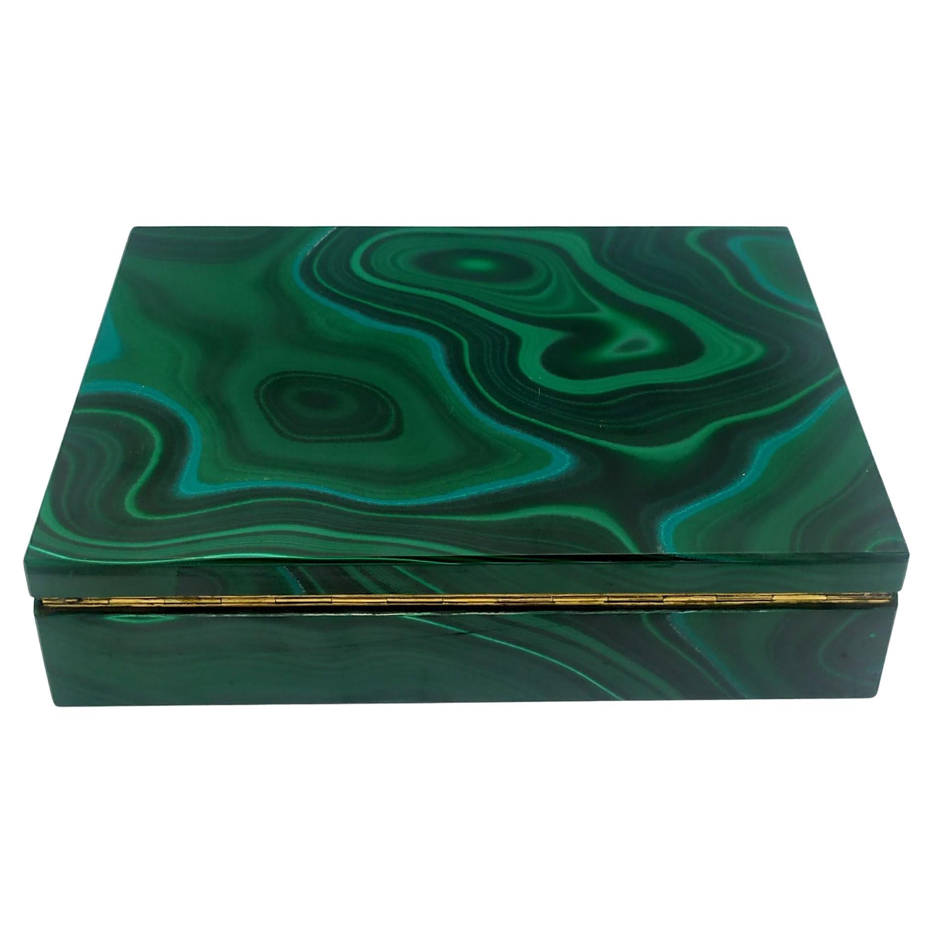 Large rectangular table box in malachite with hinged frame in 925/1000 sterling Silver gold plated. The malachite is a large single whole slab on the lid and the stone design becomes continuous on the sides. The interior is onyx from Pakistan.