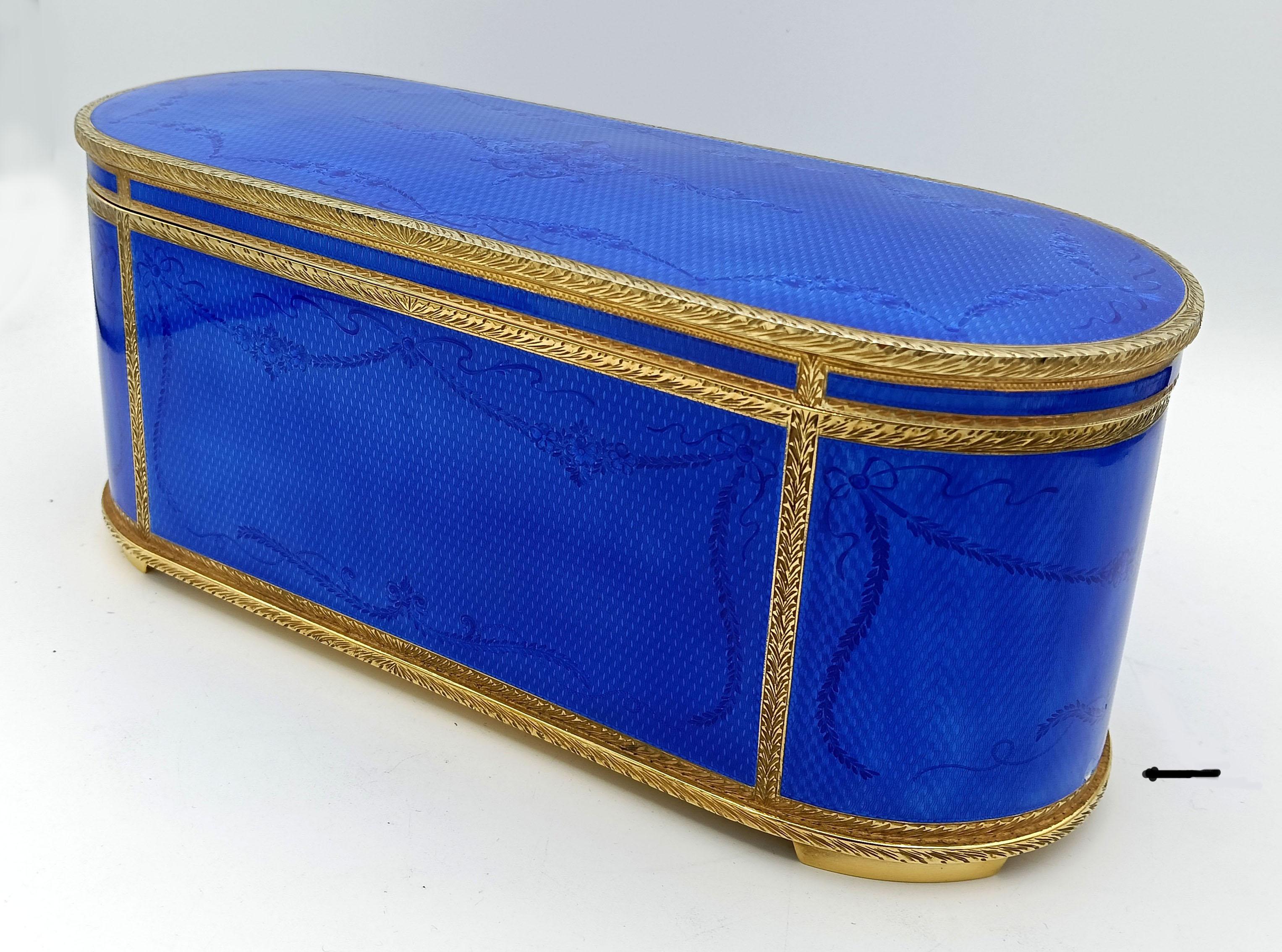 Large oval table box with mechanical musical movement by the Swiss company Reuge S.A. in 925/1000 sterling silver gold plated with translucent fired enamels on guilloché and on fine hand-engraved decorations in the French Empire Napoleon III style,