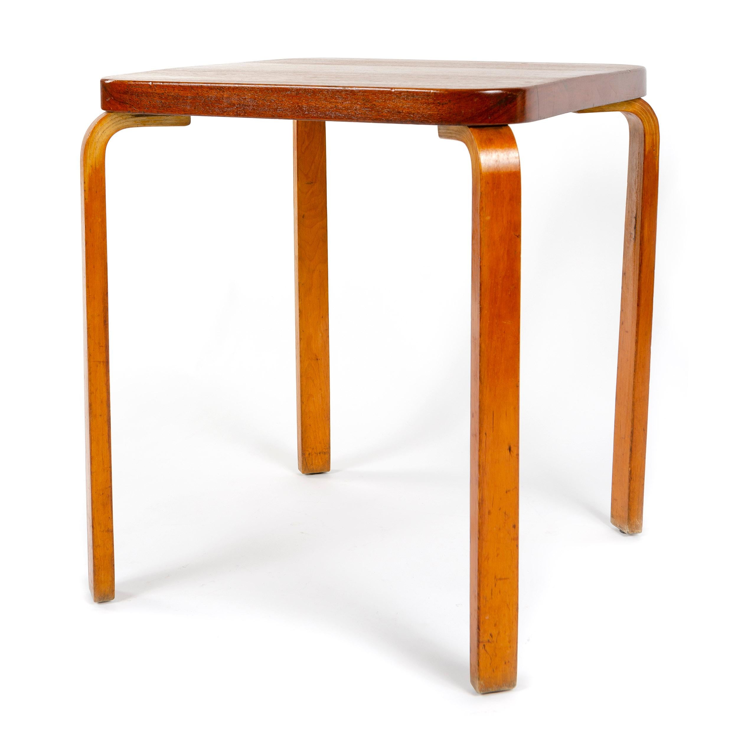 A rare, museum quality, table with a solid teak top on laminated maple legs. Retaining a partial label from the 1939 World's Fair.