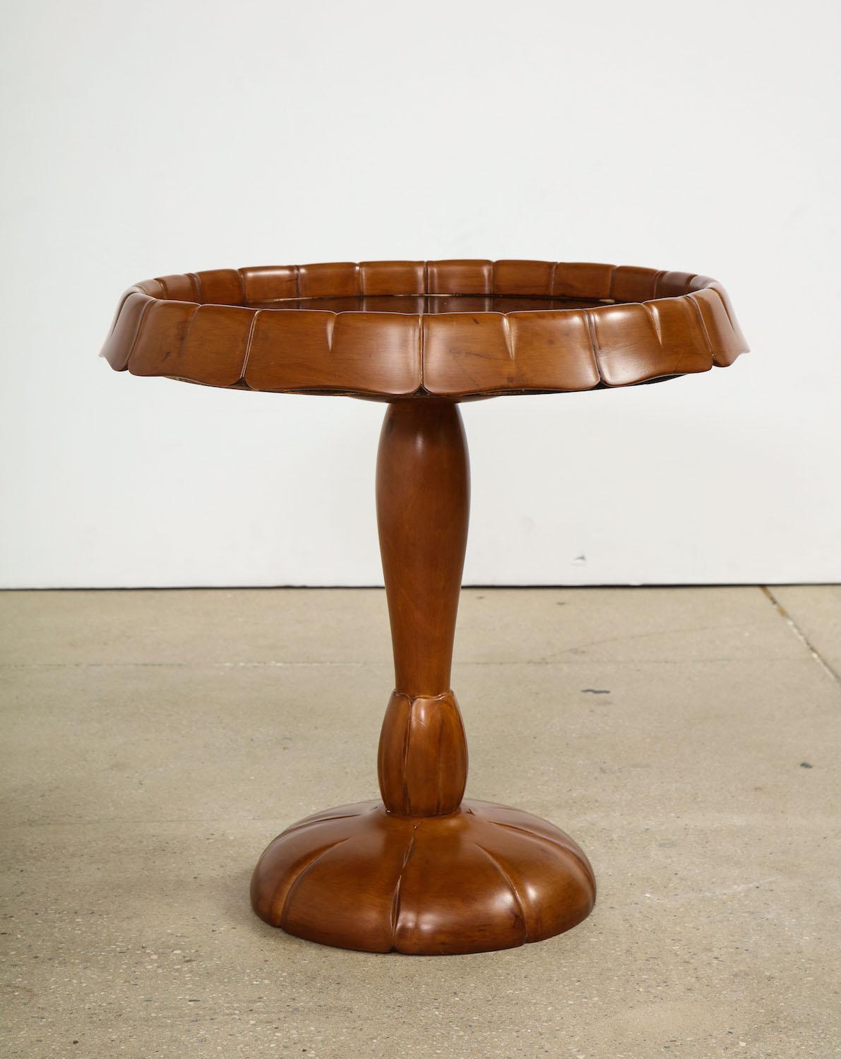 Carved pedestal table attributed to Osvaldo Borsani. Pedestal table of carved wood with relief details. Inset mirrored top.
  