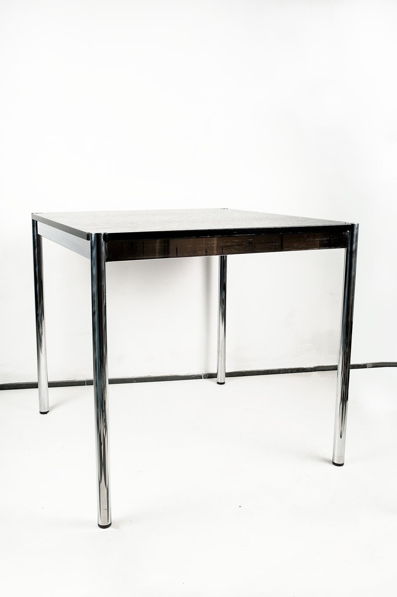Beautiful design classic, square table by USM Haller of Switzerland. Chromed steel legs, black lacquered oak top. High quality workmanship from Switzerland. Original label