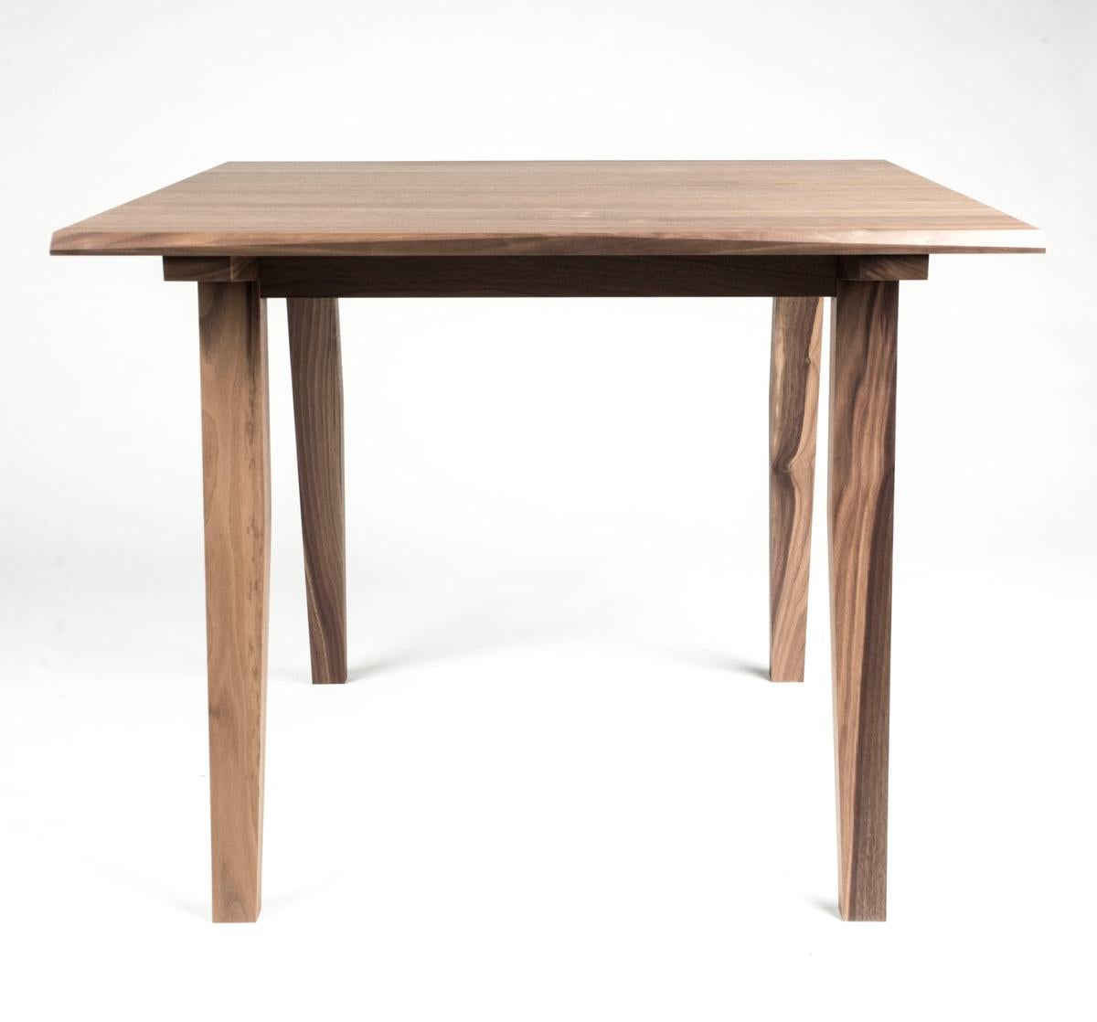 A versatile hardwood table that can be used as a card table, breakfast or apartment sized dining table. Modern styling, hand made out of hardwood and shown here in Walnut. Perfect for apartment living, fully customizable to create the perfect fit