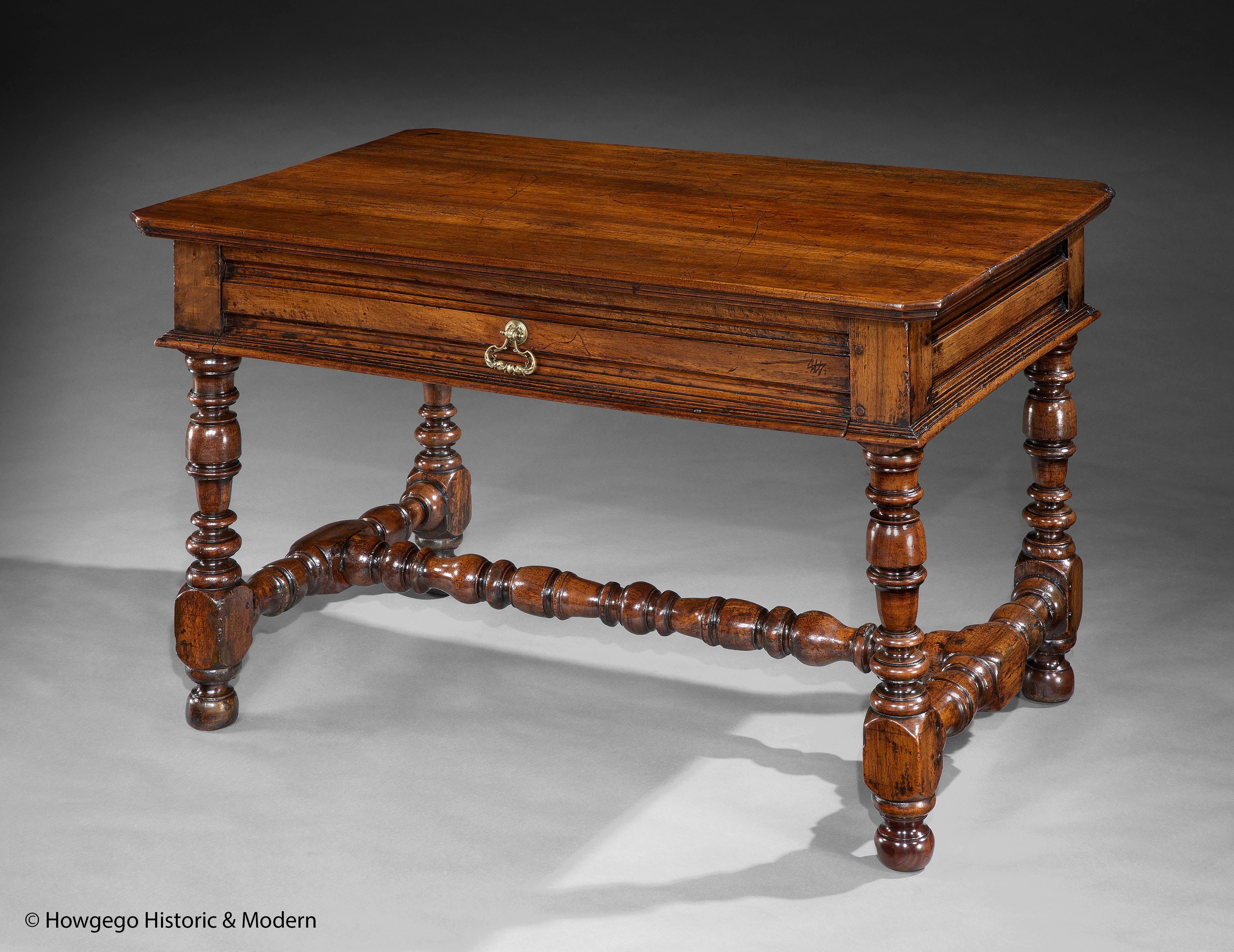Unusally Large Italian Walnut Centre, Occassional or Writing Table, Genoa

Unusual large size with classical elegance and form
Conceived as a center table as the frieze decoration is front back and sides
Rare brass handle with a pair of