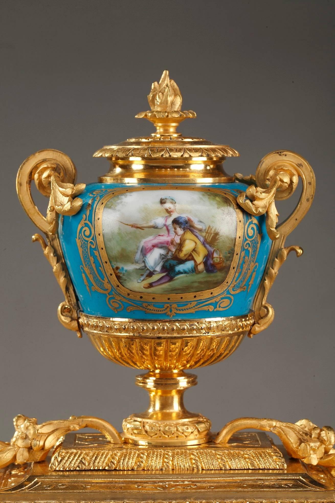 Gilt bronze antique table clock decorated with polychromatic porcelain panels. Telling the hour on Roman numerals, the timepiece features a blue and white enamel dial, painted with a gallant scene in 18th century taste. The sides are decorated with