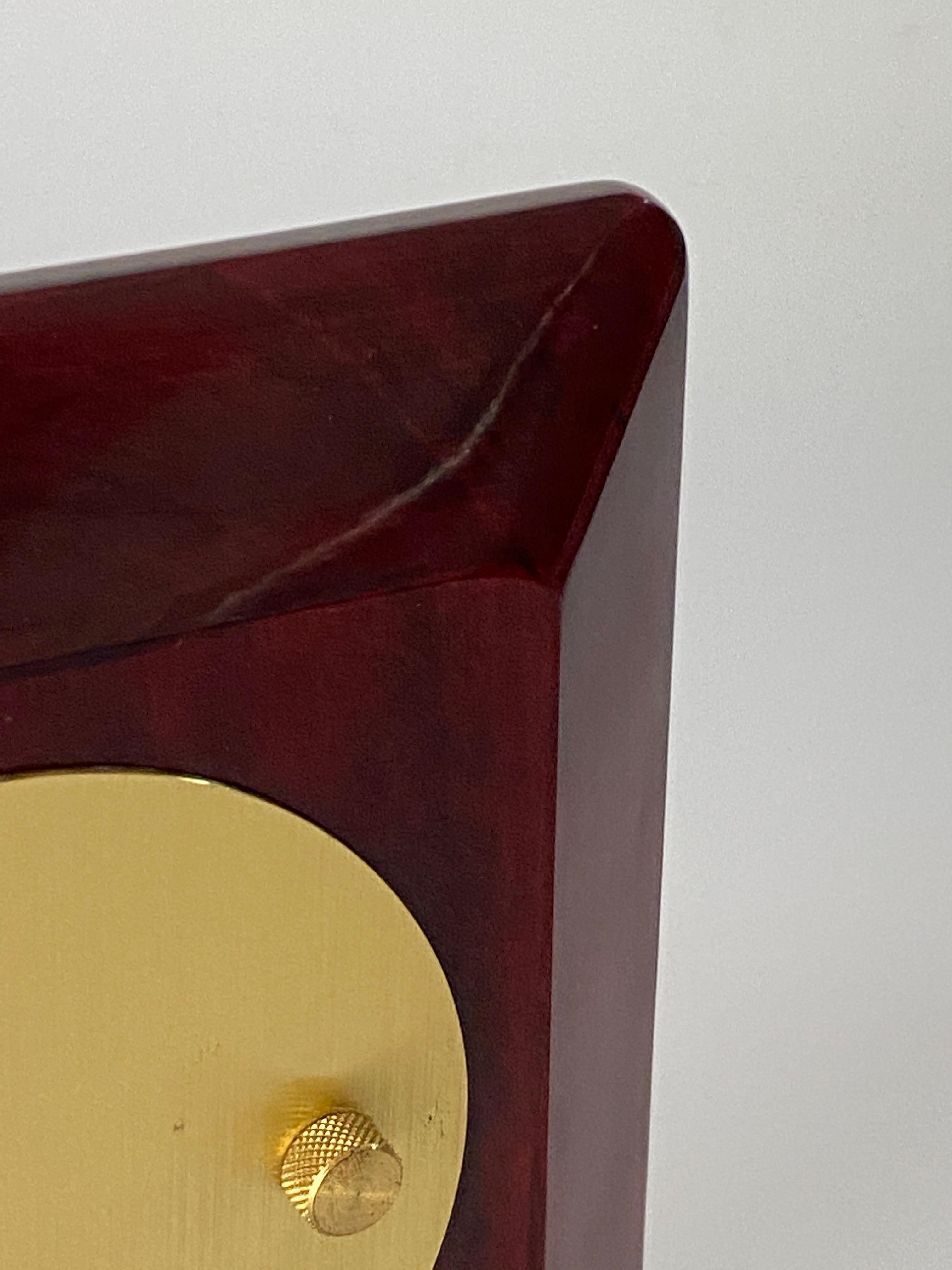 This clock is an table or desk clock. It has been made in Plastic, brass and glass, and it is heavy. It is a product from France circa 1970. The color is Burgundy.