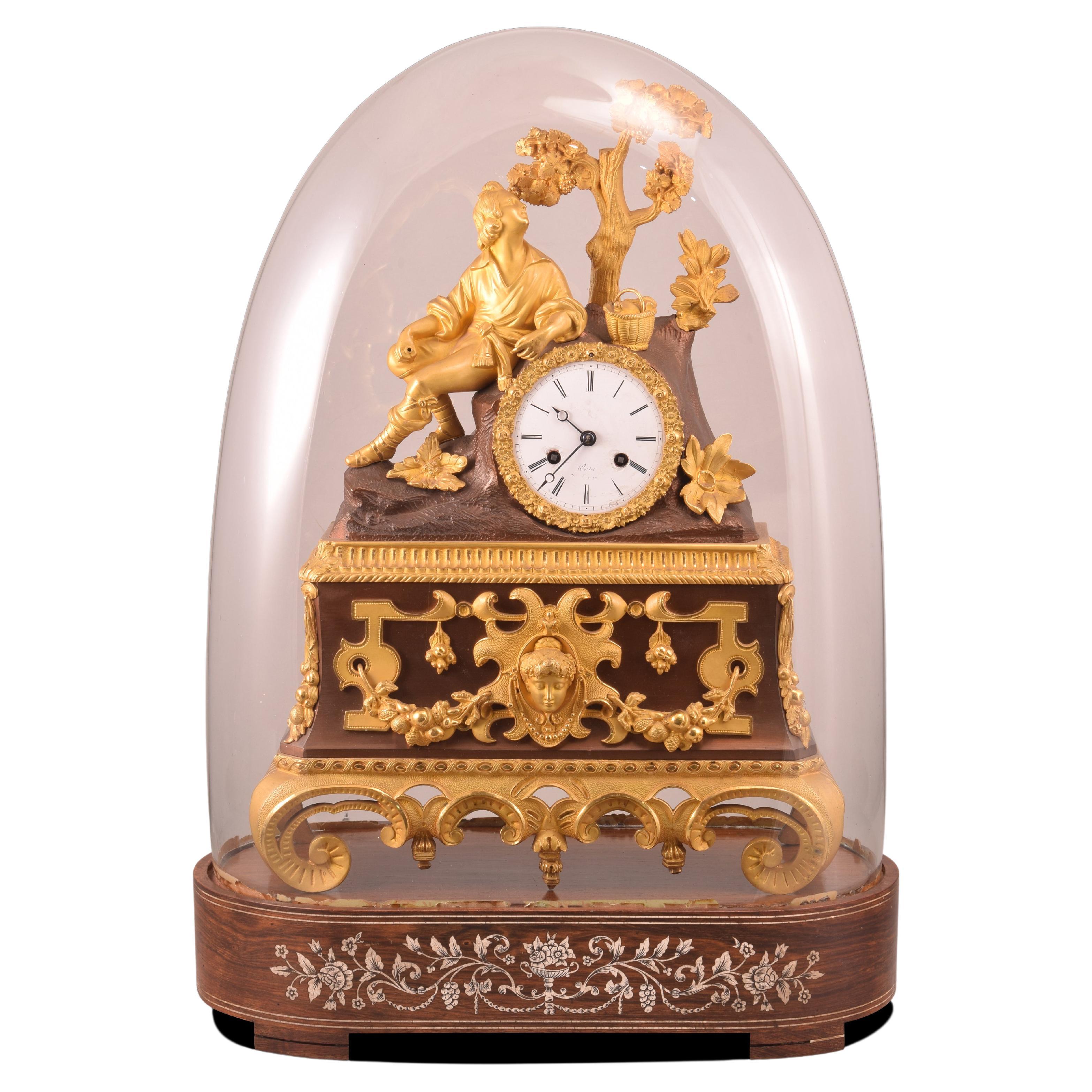 Table clock with bell glass. Wood. bronze, etc. 19th century