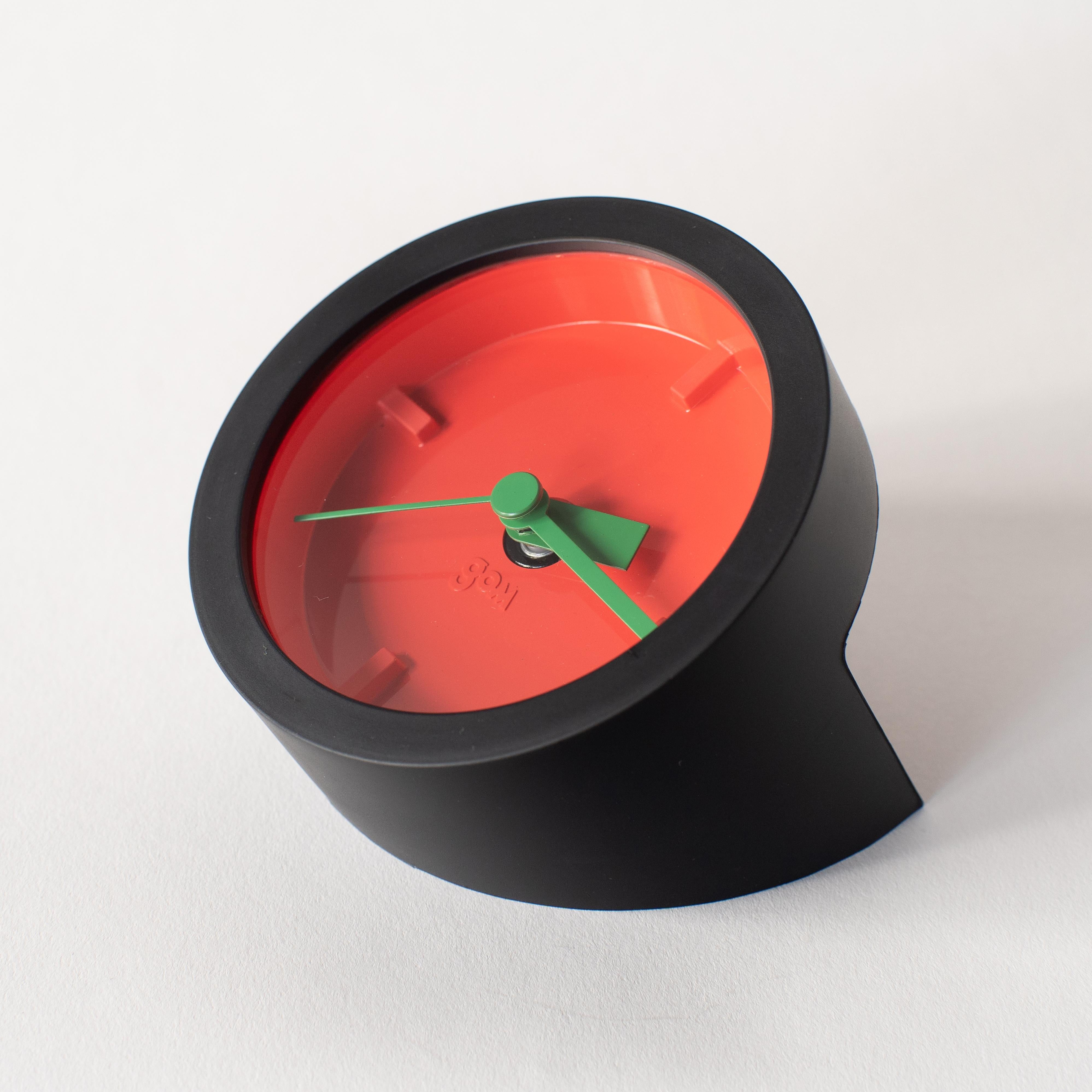 Table clock by Masayuki Kurokawa. Made of rubber frame and color board. Three color variations available.
    