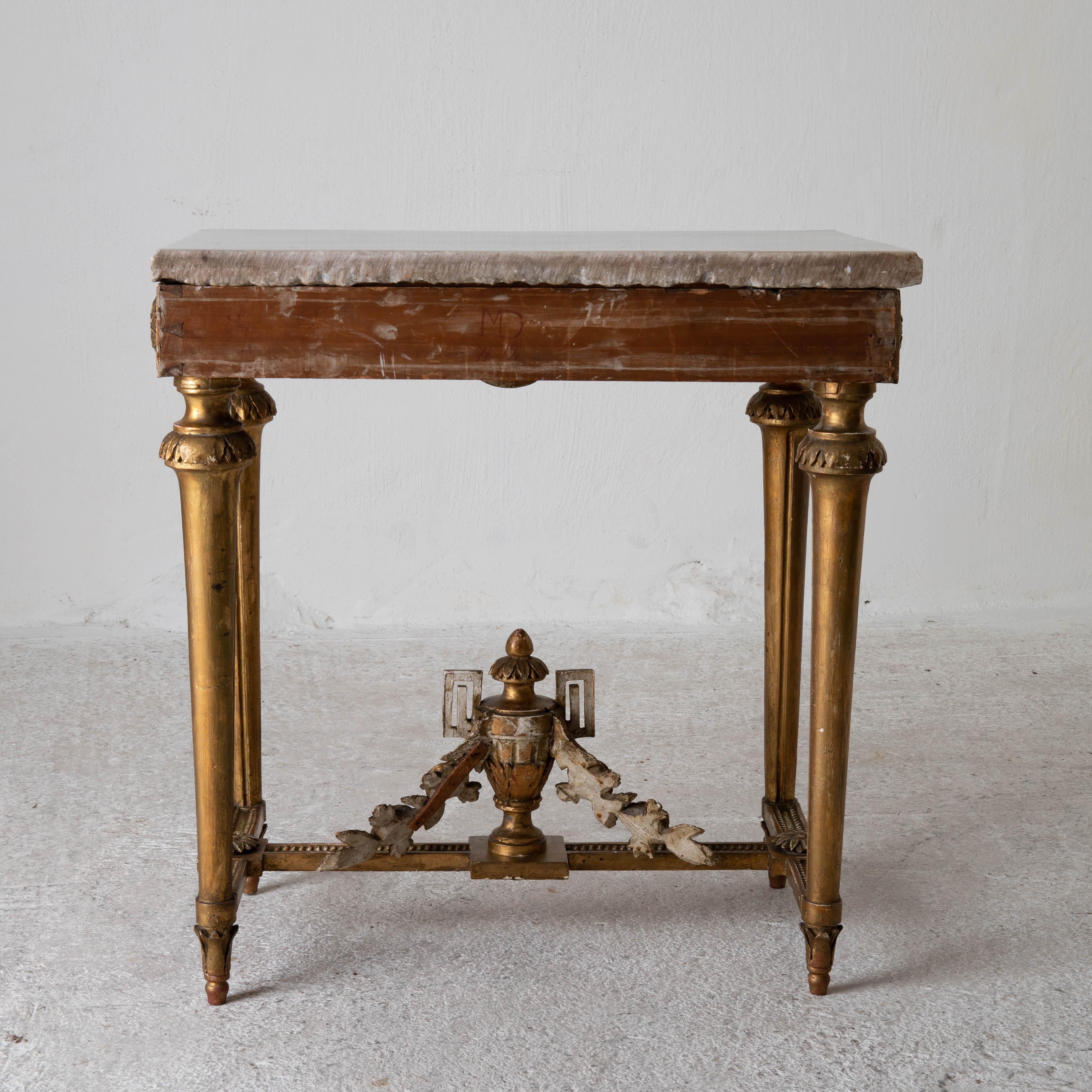 Table console rare quality Swedish early Gustavian gilded 18th century Sweden. A console table made during the Gustavian period in Sweden 1775-1790. Original gilding and white marble top. Decorated with laurel swags and channeled legs. Frieze edged