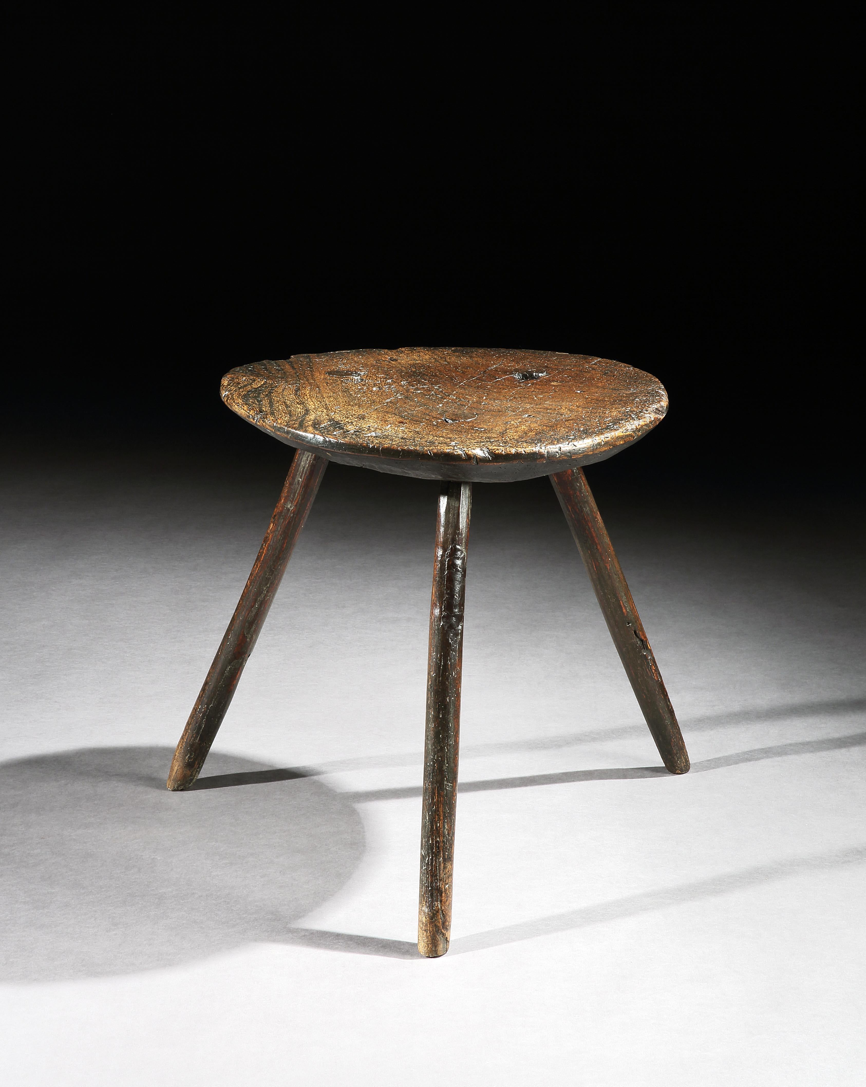 This cricket table exudes character which you expect from vernacular furniture. The thick, elm top is tactile and sculptural with beautiful figuring and an exceptional patina. It stands well on the three splayed legs which complement the sculptural