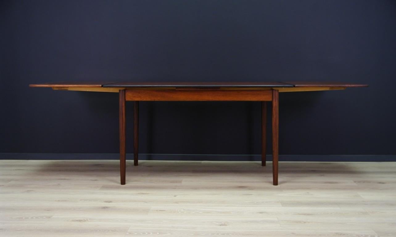 Remarkable table from the 1960s-1970s, all covered with rosewood veneer, dining table has two original inserts. Preserved in good condition (small dings and scratches, brighter spot on the table top), directly for use.

Dimensions: height 73.5 cm