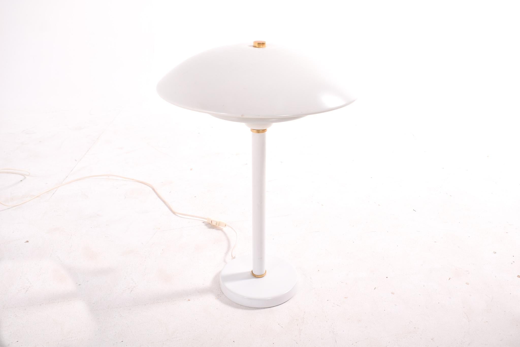 Scandinavian lamp manufacturer by Belid, Sweden in 1980s. White metal table/desk lamp. Designer unknown. The base and stand are made of steel, the lamp shades are aluminium embellished with golden rings. Manufacturer's sticker on the bottom of the