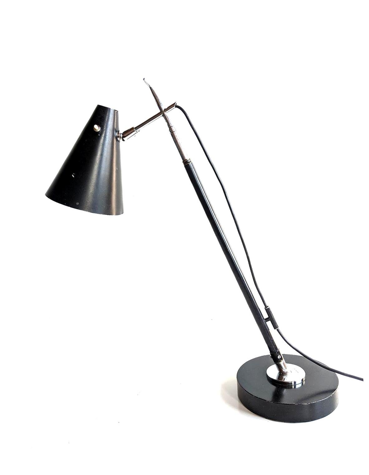 Lamp designed by Giuseppe Ostuni, circa 1955, and produced by O-Luce of Milan, Italy. Lamp converts from a table lamp to a floor lamp due to the telescoping body. There is also a ball joint fitting at the base of the body, so that you can also