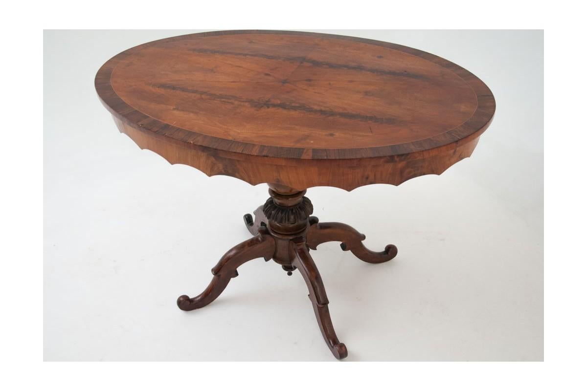 Oval walnut table from the turn of the century.

Dimensions: height 74 cm / length 108 cm / width 72 cm

The antique table was made at the turn of the century in walnut wood. The furniture has an oval table top on a wide frame supported on a