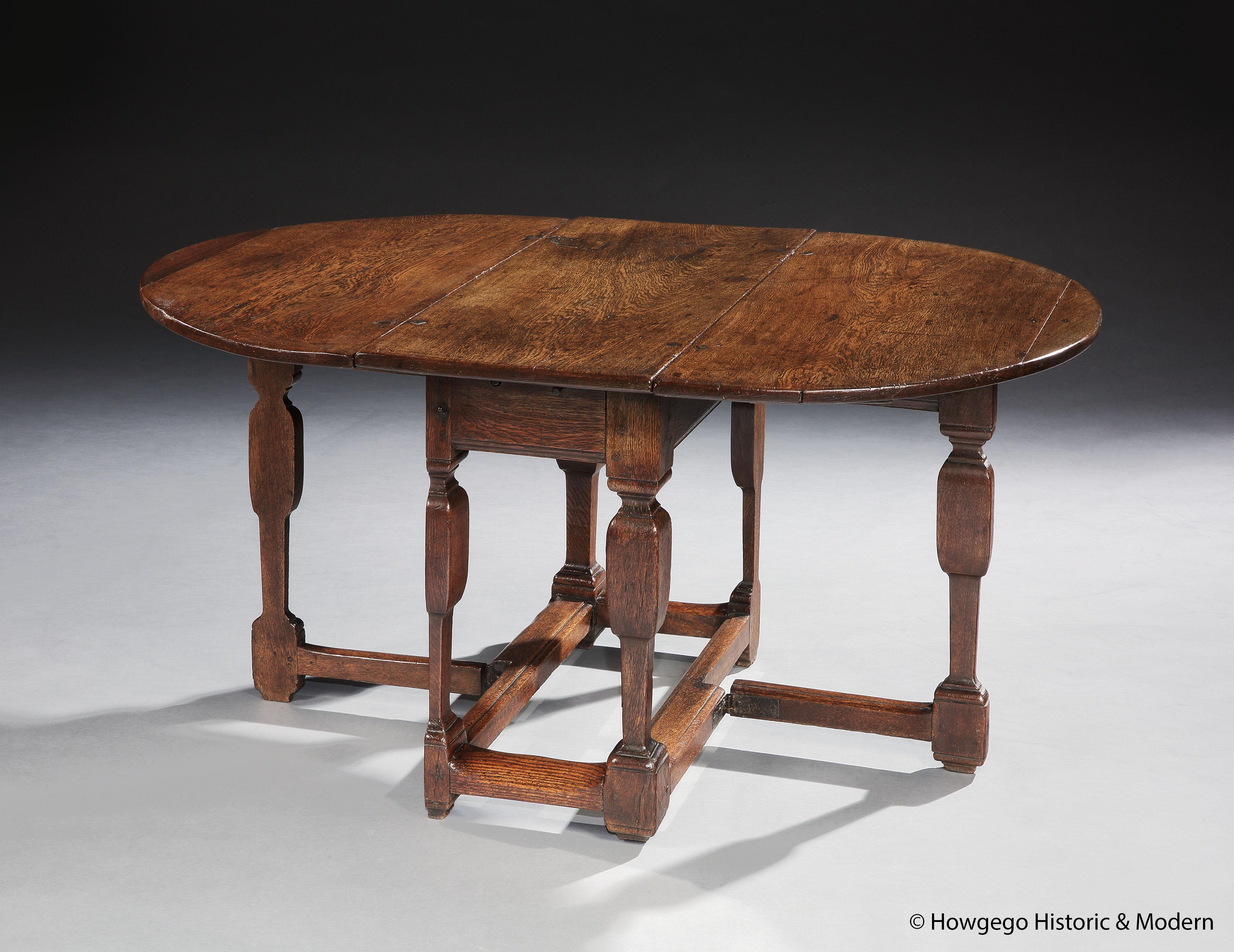 AN UNUSUAL, FLEMISH, BAROQUE, OAK, SPLIT, GATELEG, OVAL TABLE WITH ORIGINAL IRONWORK & SINGLE DRAWER, 5ft

- The turnings are architecturally inspired and the split leg creates a pared down, elegant silhouette
- Characterful table oozing Flemish