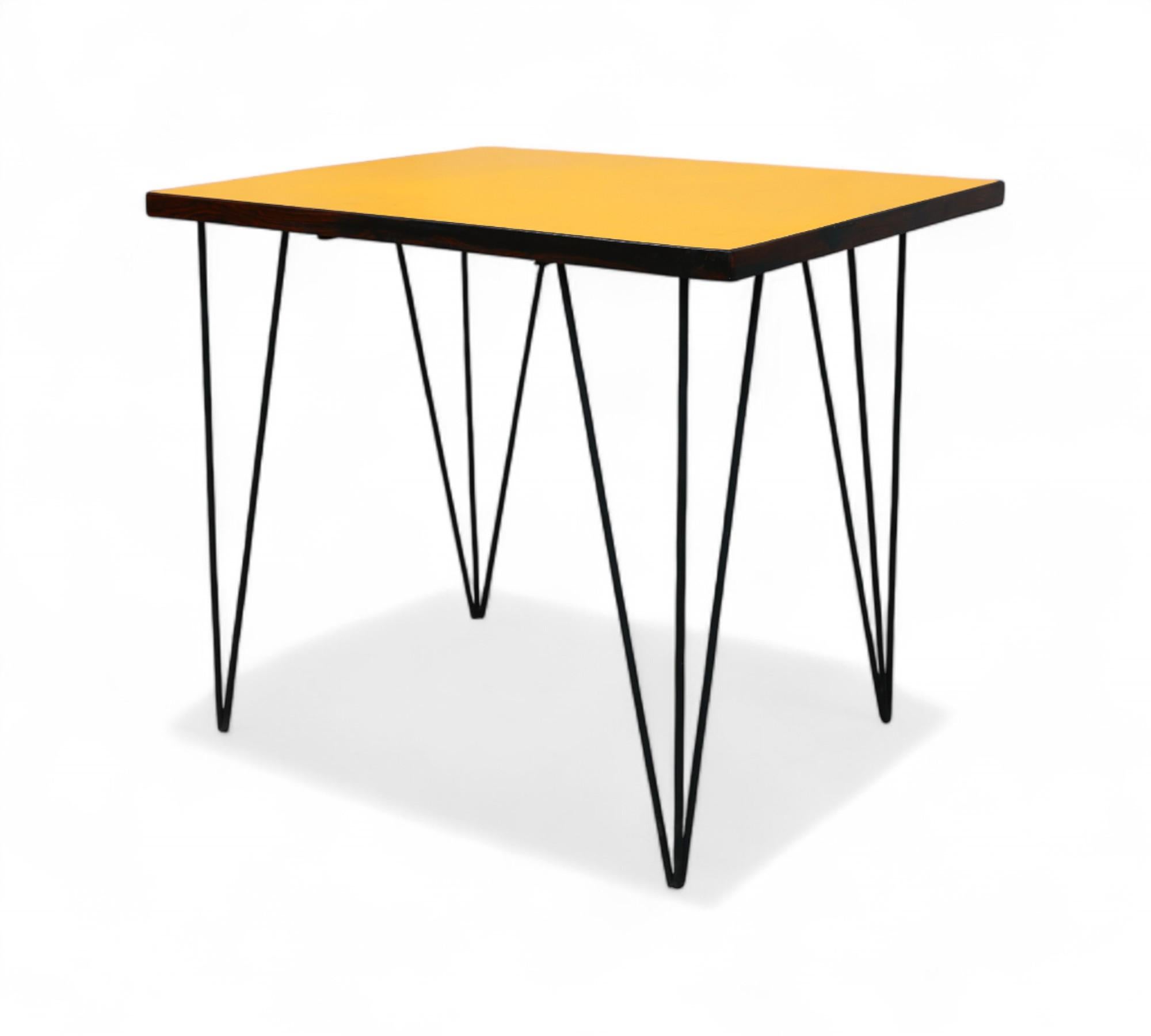 This striking table showcases a robust hardwood top elegantly finished in vibrant orange Formica. Its solid iron legs provide both strength and stability to its design.

Additional information:
Materials and Techniques: Iron, Formica
Style: