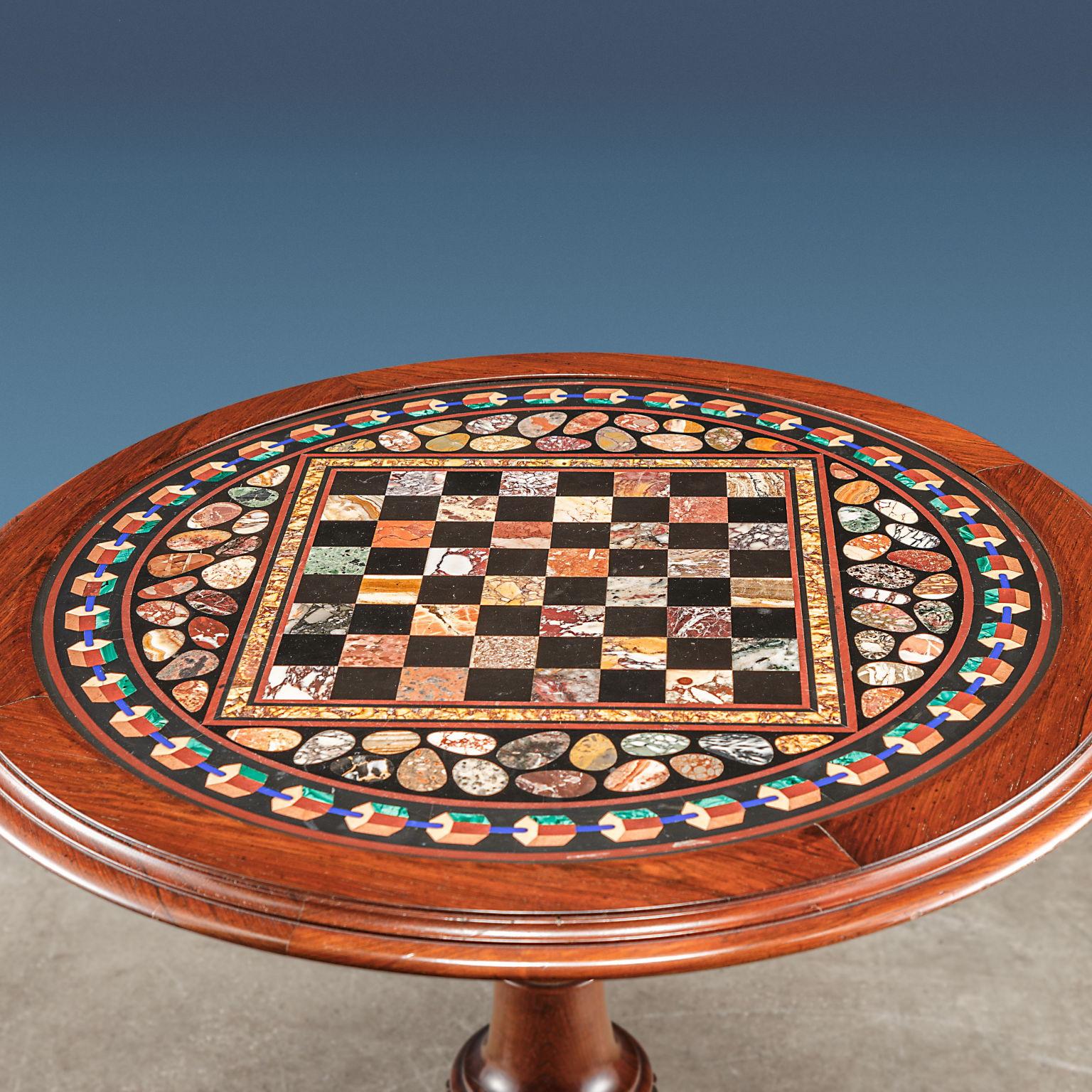 Circular top in marble committed, with polychrome chessboard in the center; the marble is framed in a rosewood support, supported by a central turned baluster resting on three shaped and fluted feet.
The octagonal top in polychrome marble works