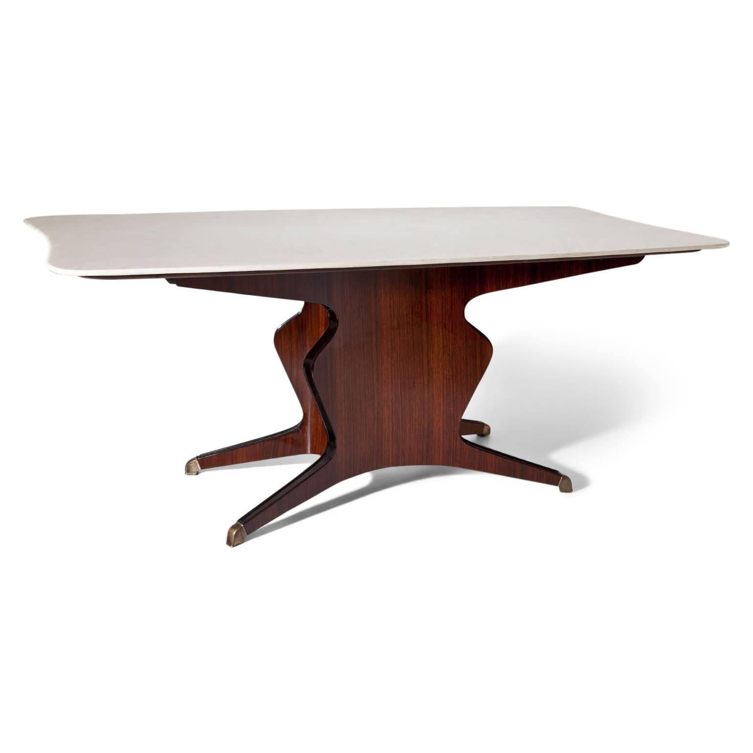 Large dining room table with white onyx top on a scalloped base with four feet. The tabletop is convex and concave curved and labelled at the bottom “Mobilifico Fratelli Turri - Carugo”. The table is in a very good, refurbished and hand-polished