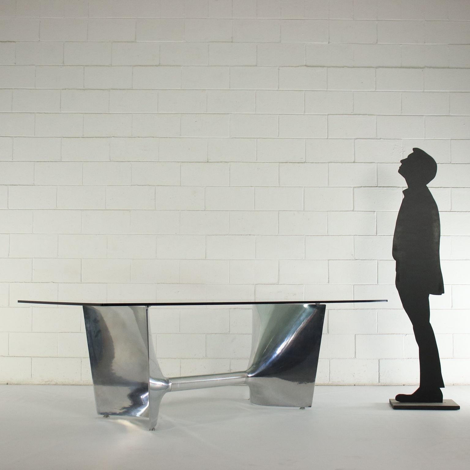 Table, chromed cast aluminium base, glass top.