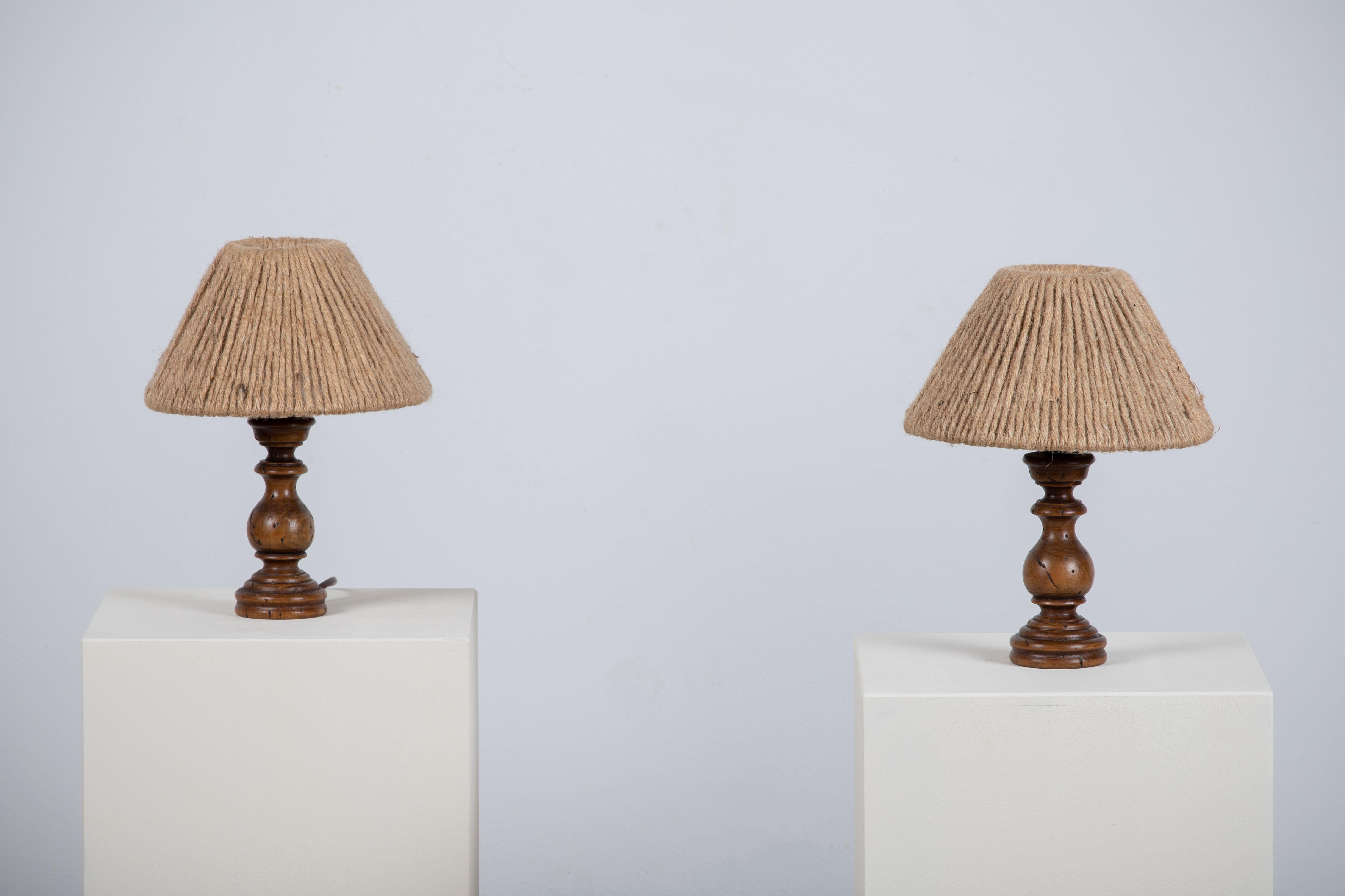 A craft table lamp pair. In solid oak, France, 1960. 

Elegant pair of oak hand-carved lamps, Without lampshade. It is in good general condition and works perfectly. The diffused light is very pleasant and the lamp offers a warm atmosphere.

Height