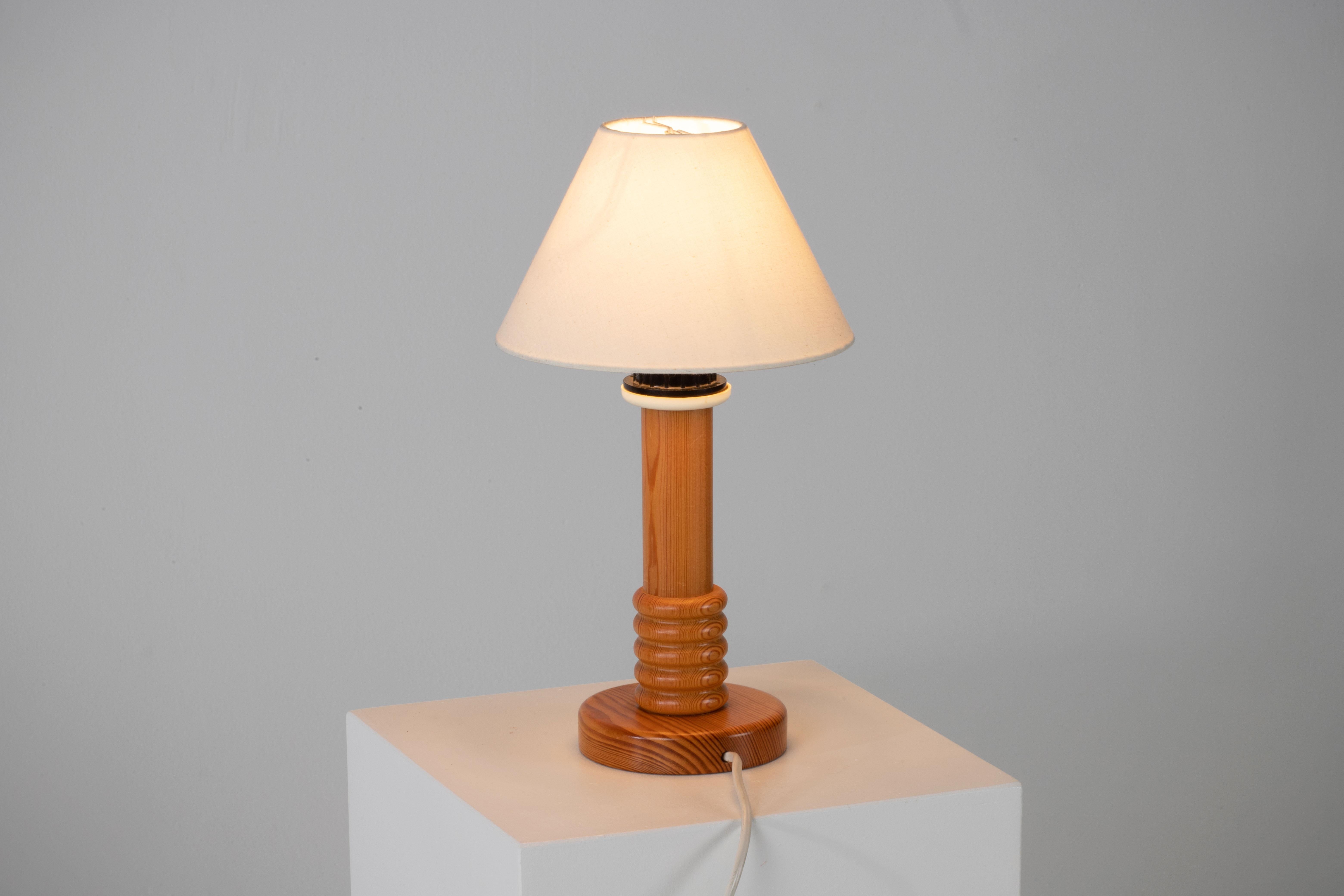 Introducing a stunning pair of mid-century table lamps that exude timeless elegance and style. Crafted from solid pine, these lamps were made in Denmark during the 1960s, showcasing the iconic design influence of Uno Kristiansson.

These lamps are