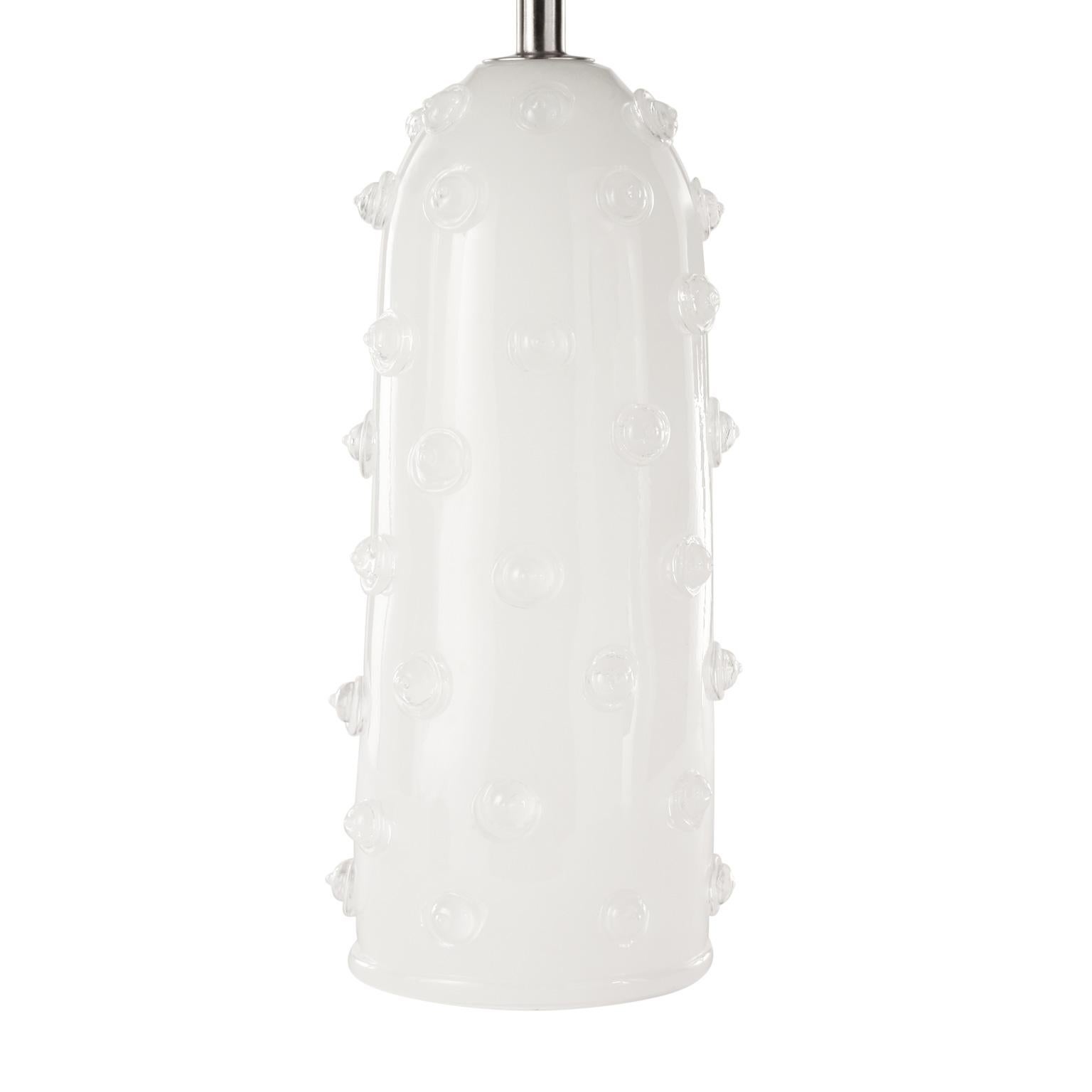 Table lamp silk artistic Murano glass, clear “Borchie”(particular application in glass on the base), grey organza lampshade. Nickel fixture.
The handcrafted soul of our lighting products is reinvented every time we start a new project, when we are