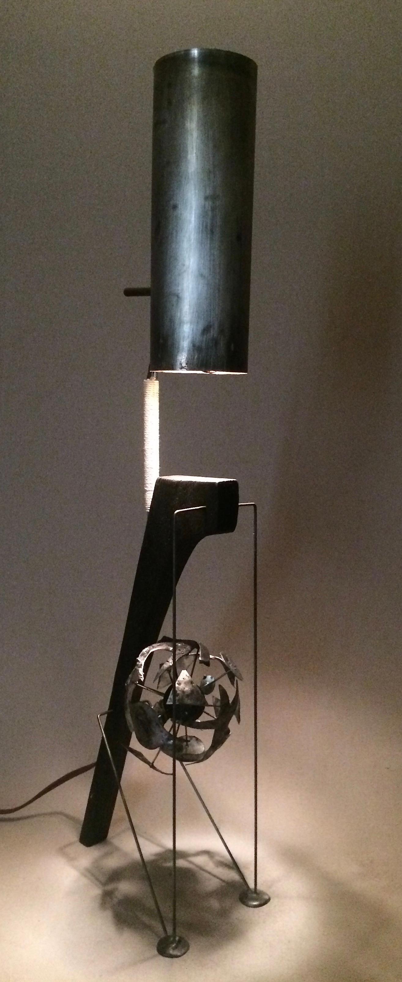 Table lamp, a sculptural light fixture by American artist Adam Henderson. This Industrial style lamp has a sort of nuclear reaction occurring in the bottom of the composition.