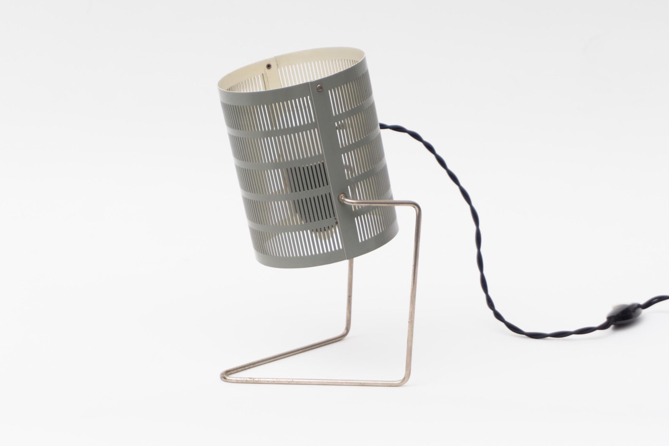 Fine table lamp made of perforated aluminum, lacquered grey. Chromed metal structure.