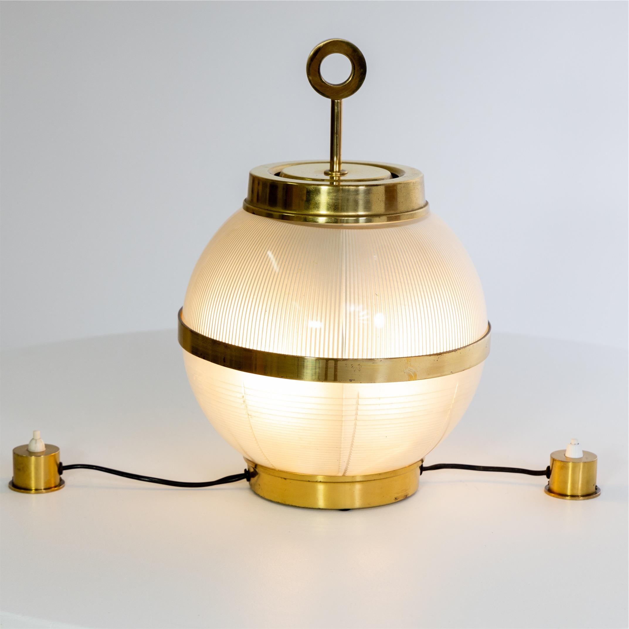 Table lamp with spherical glass body with brass mounts and two separate light switches.