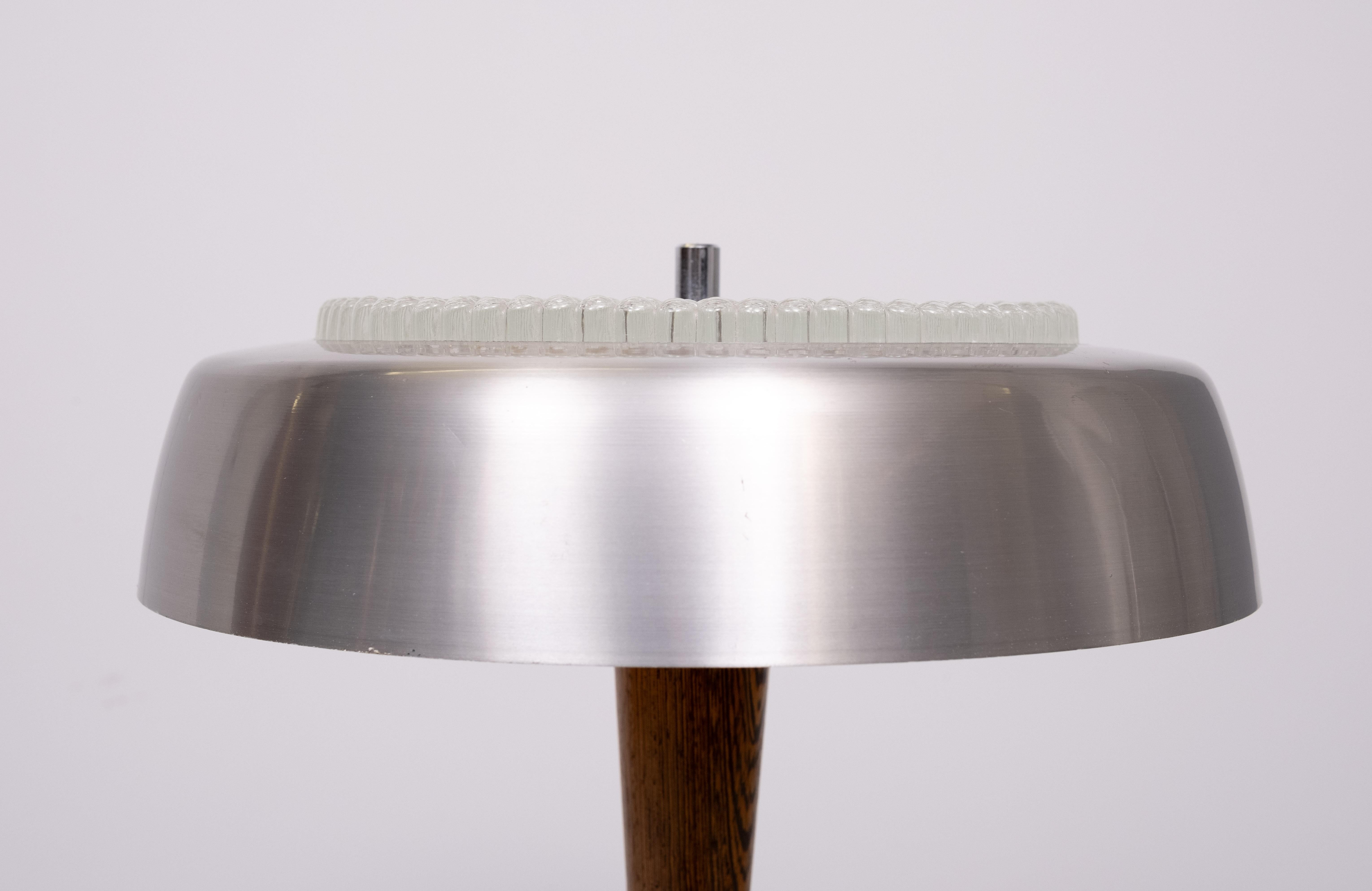 Beautiful table lamp. Very nice quality . Aluminum ,comes with 
Wenge Wooden upright , Thick dewdrop Glass top . 3 large E27 bulbs needed .Switch on the base . 1960s . Very good condition . 
 