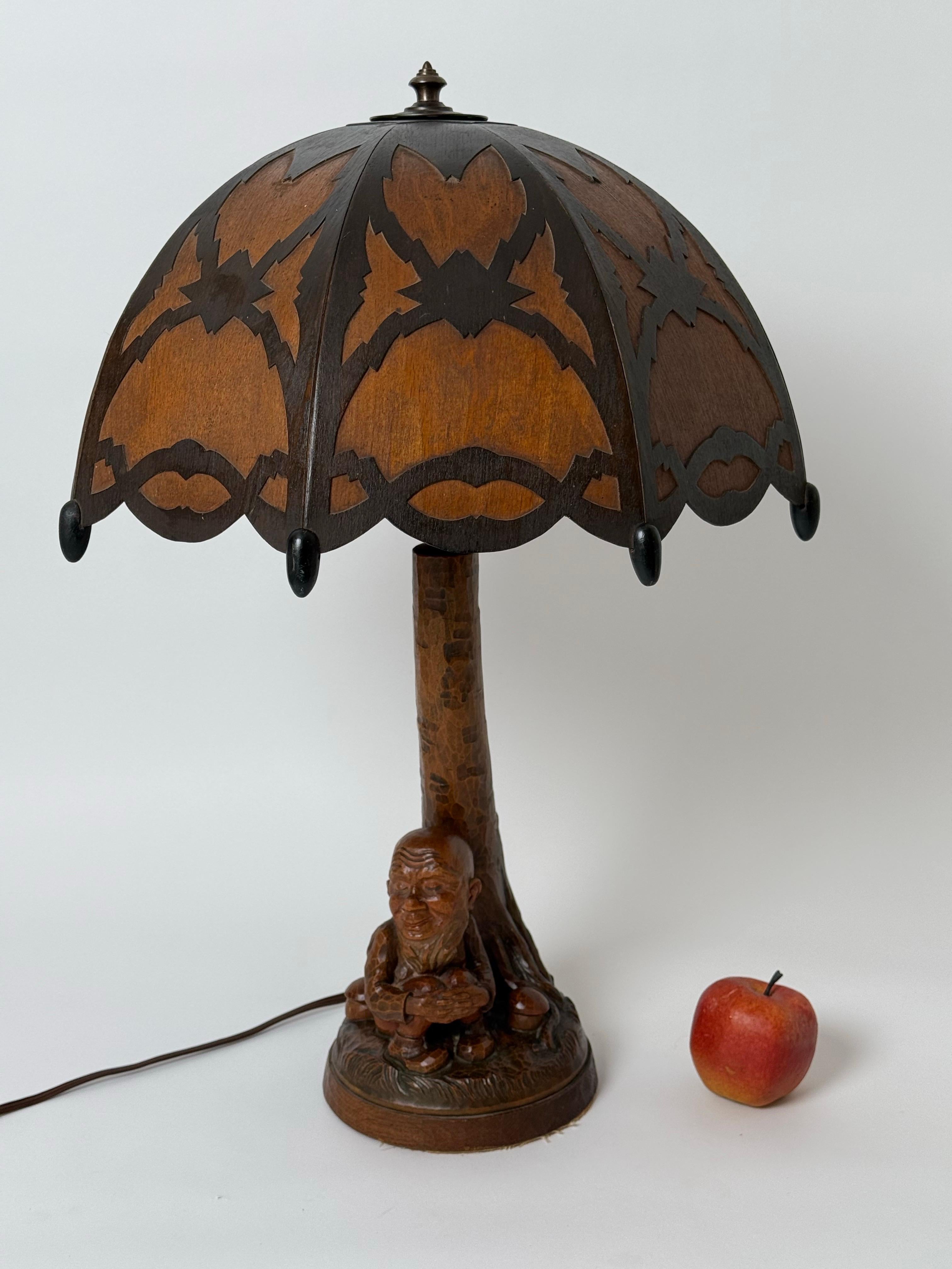 Take a look at this unique and extremly beautiful table lamp, which is a rare masterpiece of German craftsmanship and design. Age does nothing to its beauty. The lamp base was elaborately carved by hand with very experienced craftsmanship and shaped